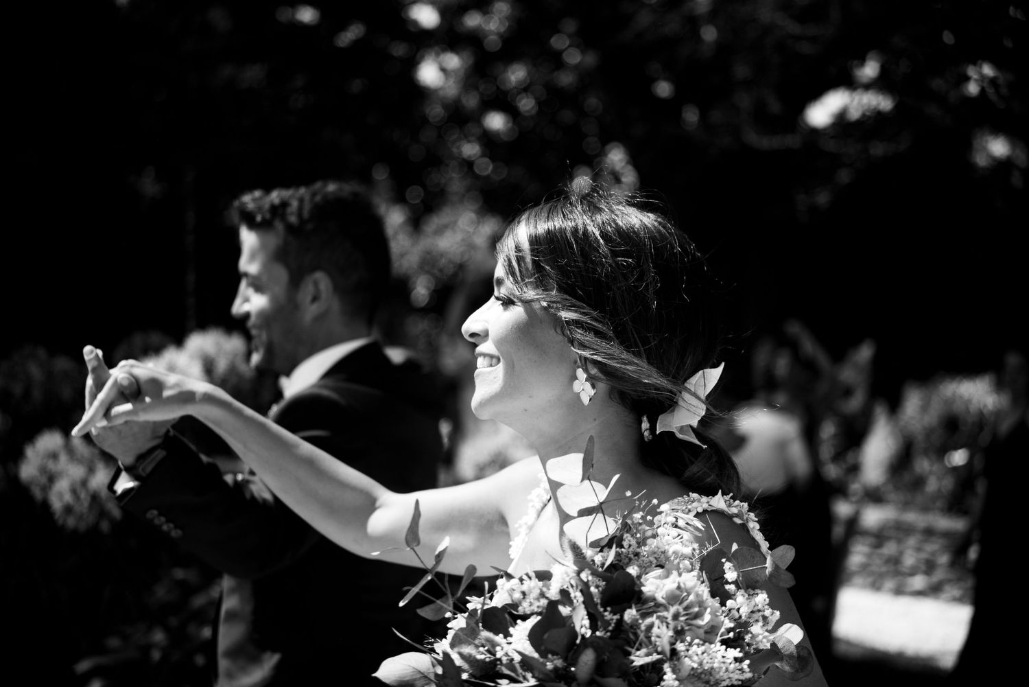 A black and white photo shows people dancing in an intimate moment at what appears to be a wedding reception.