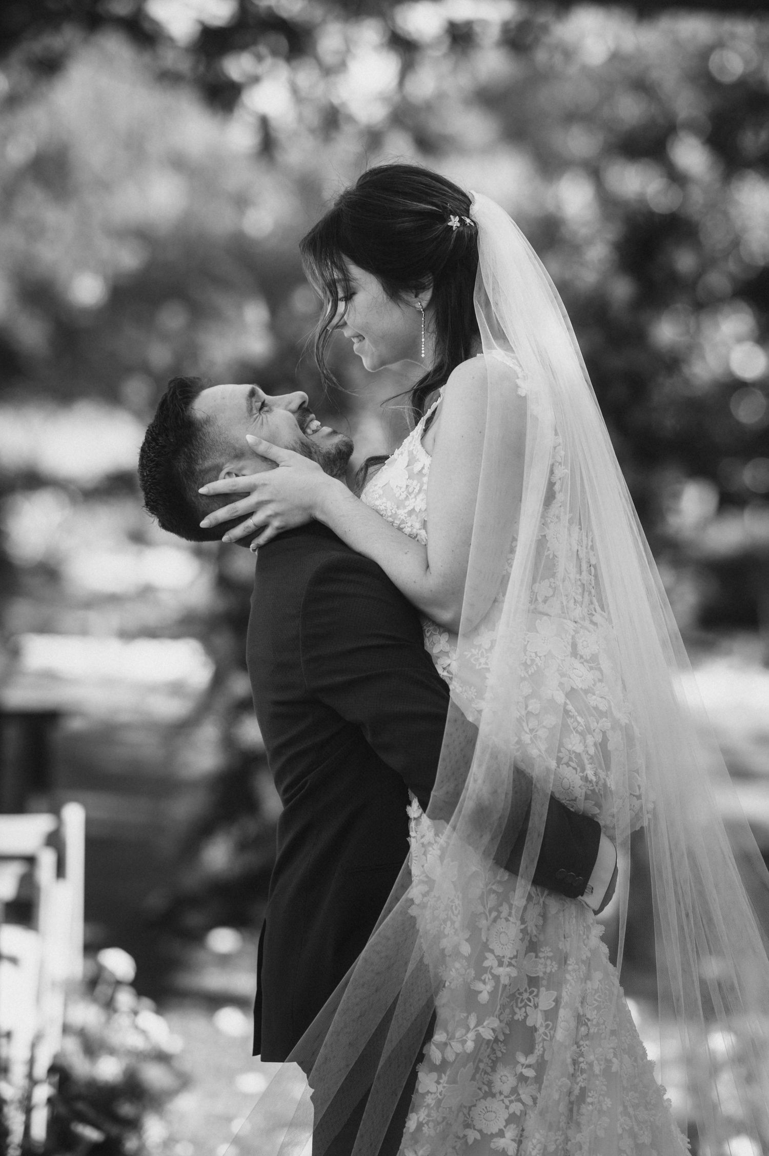 A series of romantic black and white wedding photos showing a couple embracing and dancing outdoors.