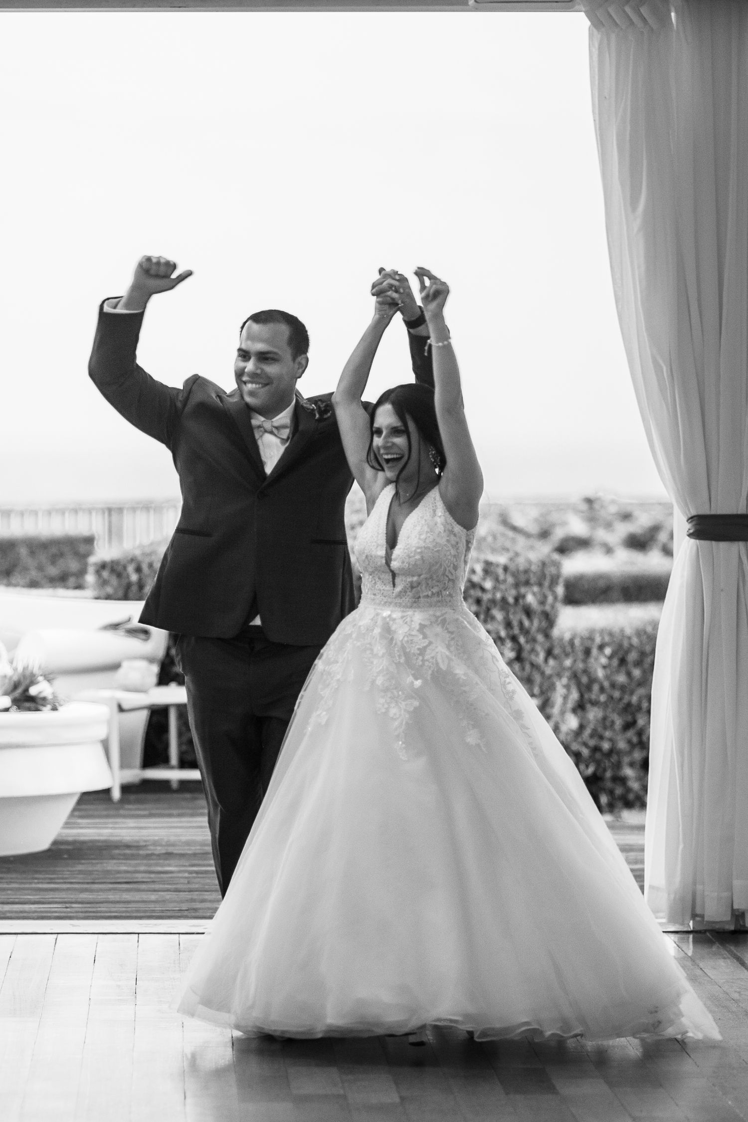 Black and white series of wedding photos showing a couple dancing and twirling in formal attire.
