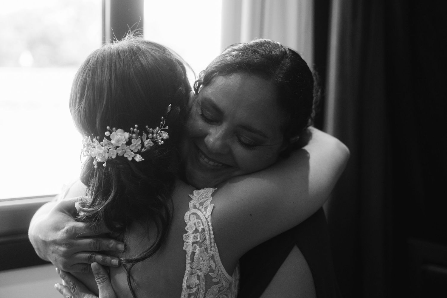 A tender moment shared between two people in black and white photography.