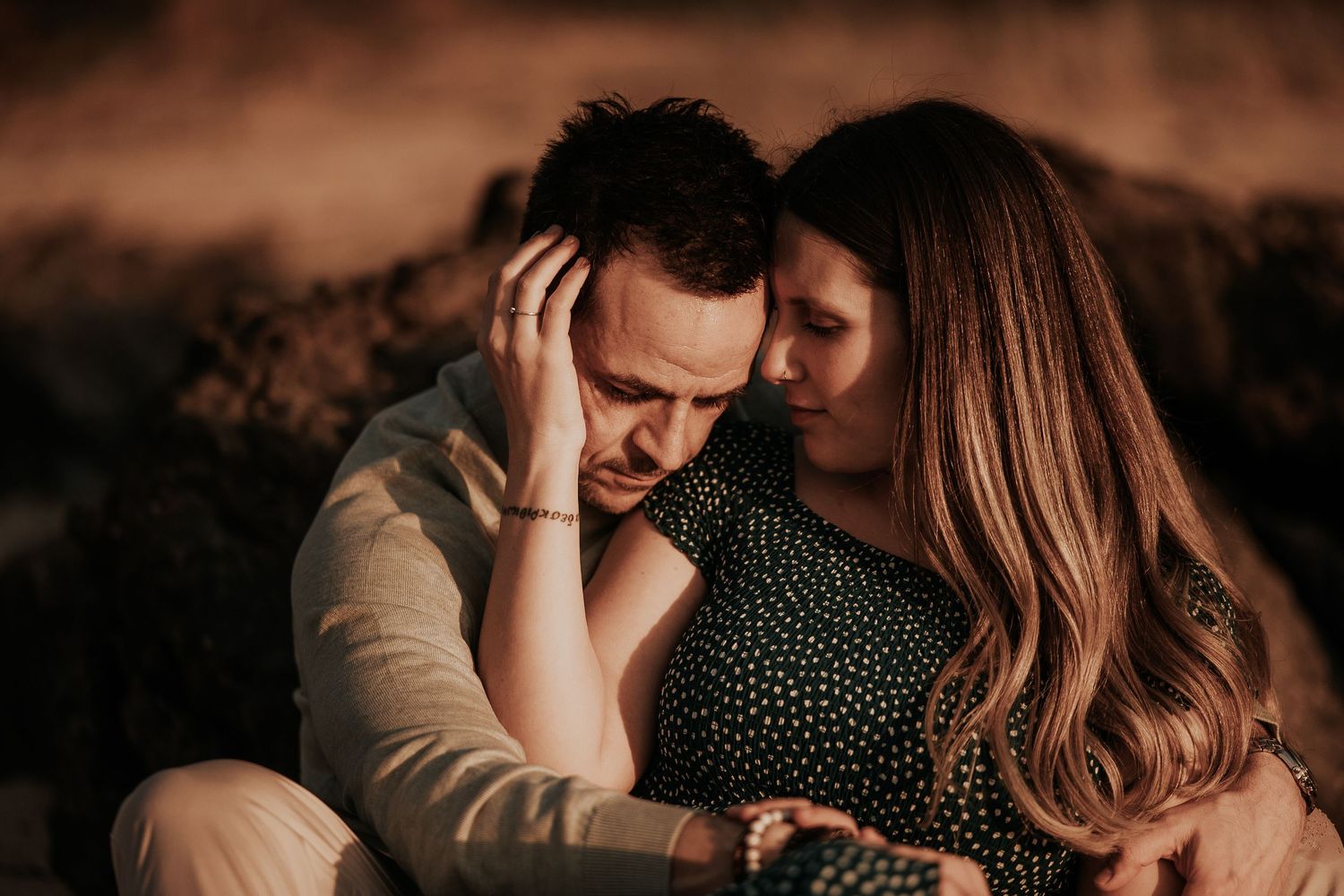 Romantic couple embraces during golden hour sunset in a series of intimate outdoor portrait photographs.