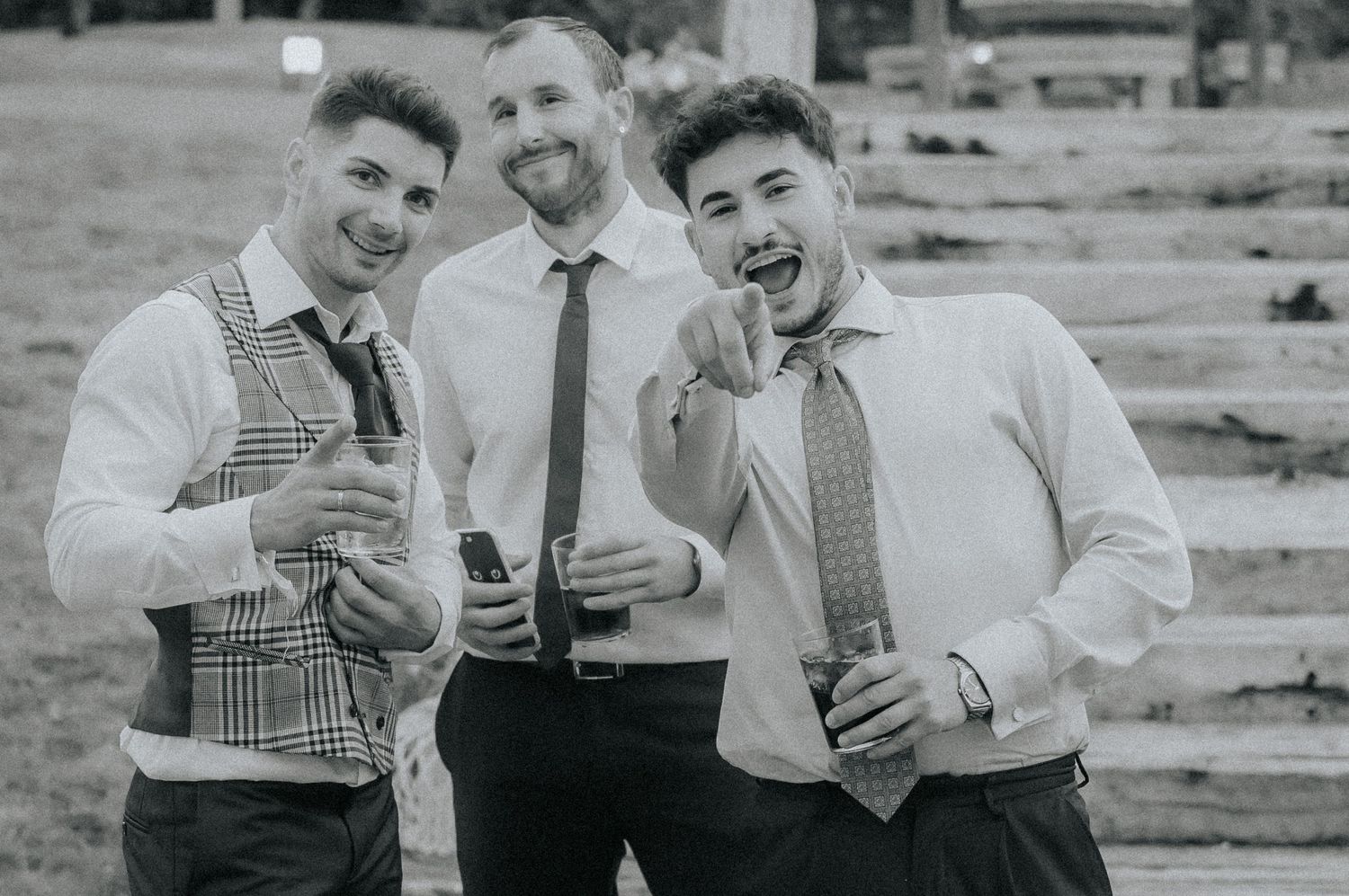 A group of people in vintage attire from the 1950s enjoying drinks and socializing at an outdoor gathering.