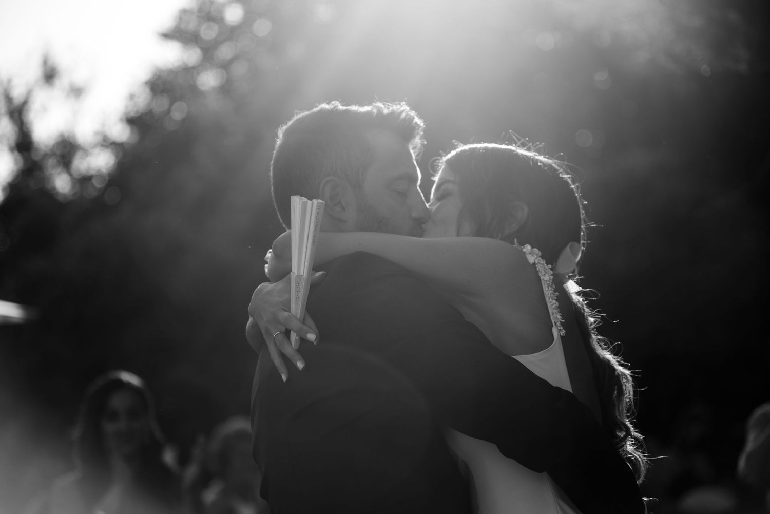 Silhouetted figures dance in dramatic backlit black and white photography.