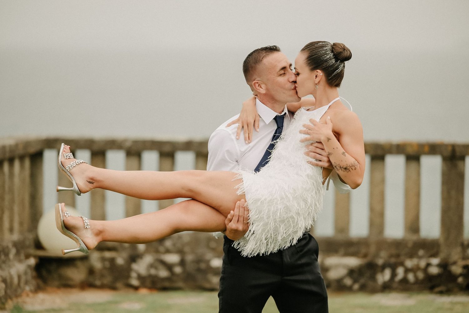A couple dances together in an elegant ballroom setting, performing graceful dance moves in formal attire.