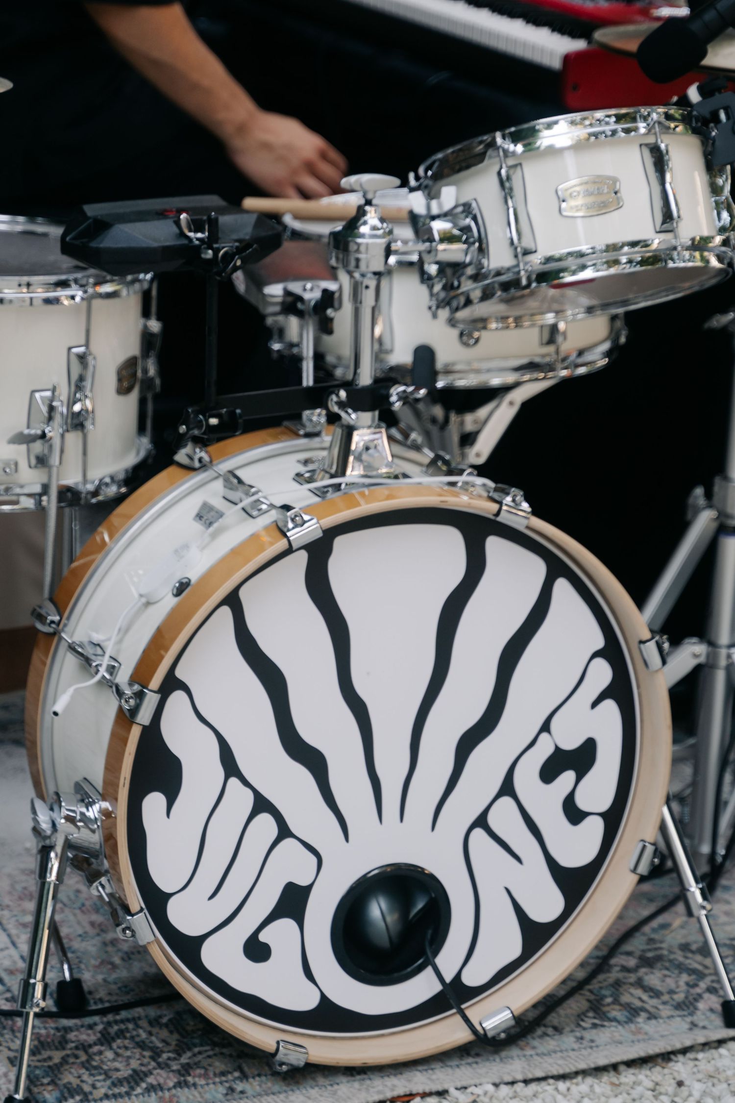 A close-up sequence showing the artistic black and white design on a bass drum head of a drum kit.