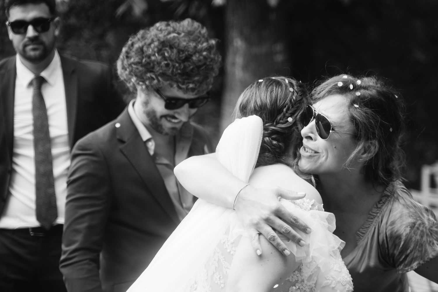 Black and white wedding photos showing romantic moments between newlyweds during their outdoor celebration.