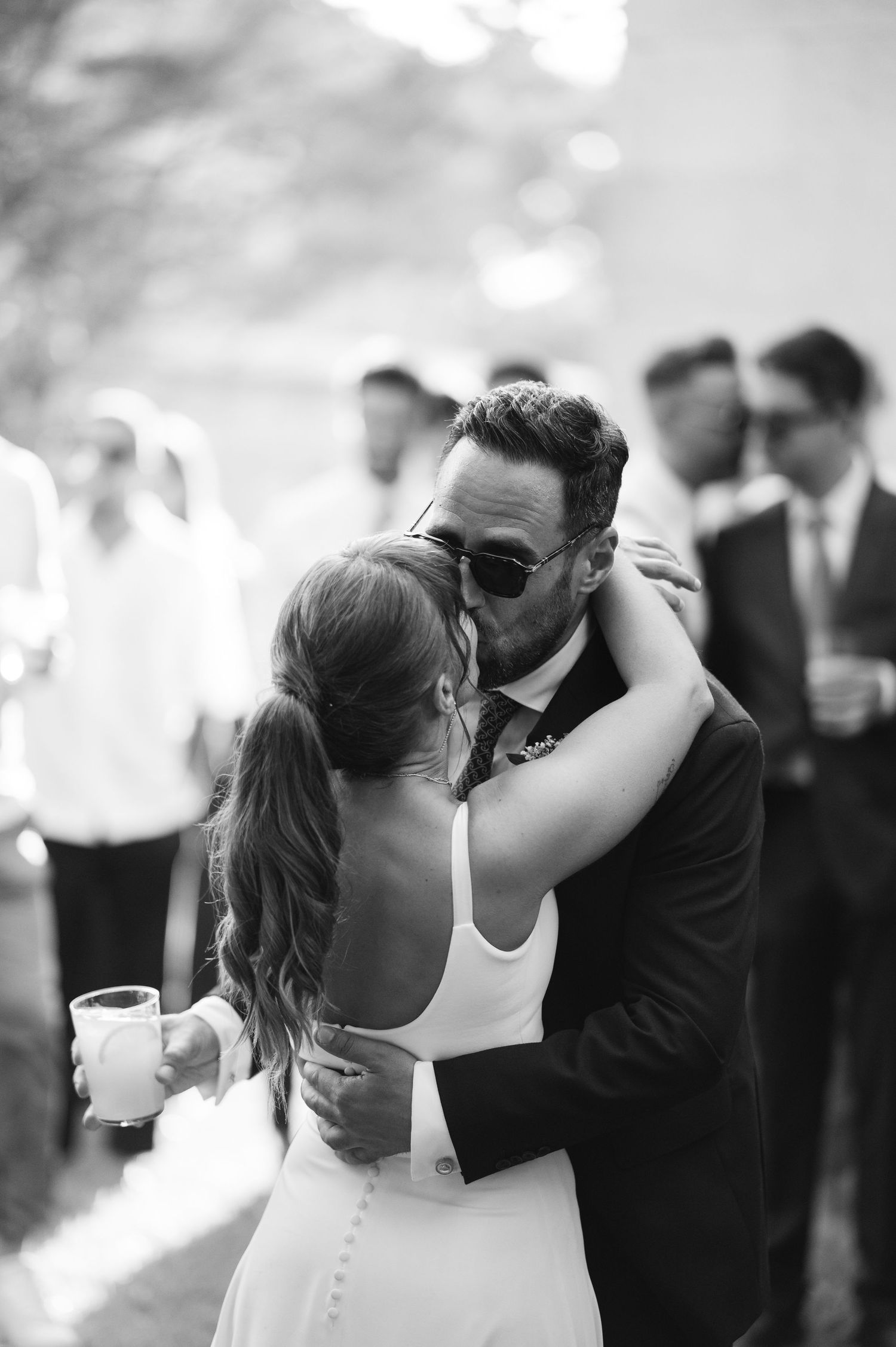 A series of romantic black and white wedding photos capturing intimate moments between newlyweds.