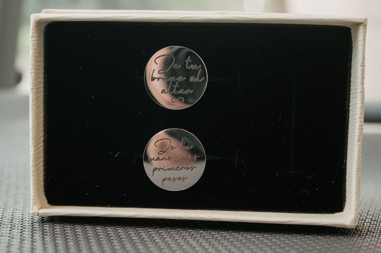 Three vintage black velvet jewelry boxes with metallic embossed logos displayed in a row on a white surface.