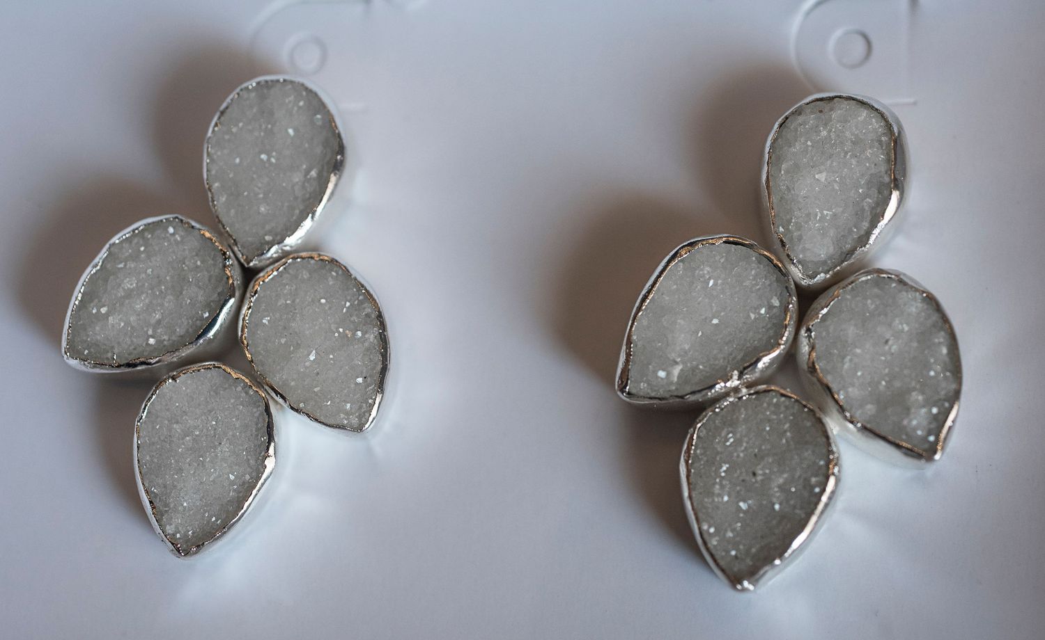 A sequence showing ice crystals forming and growing into delicate butterfly-shaped patterns on a frosty surface.
