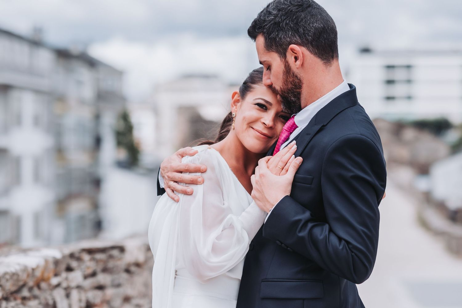 A romantic wedding couple embraces in an intimate outdoor moment during their special day.