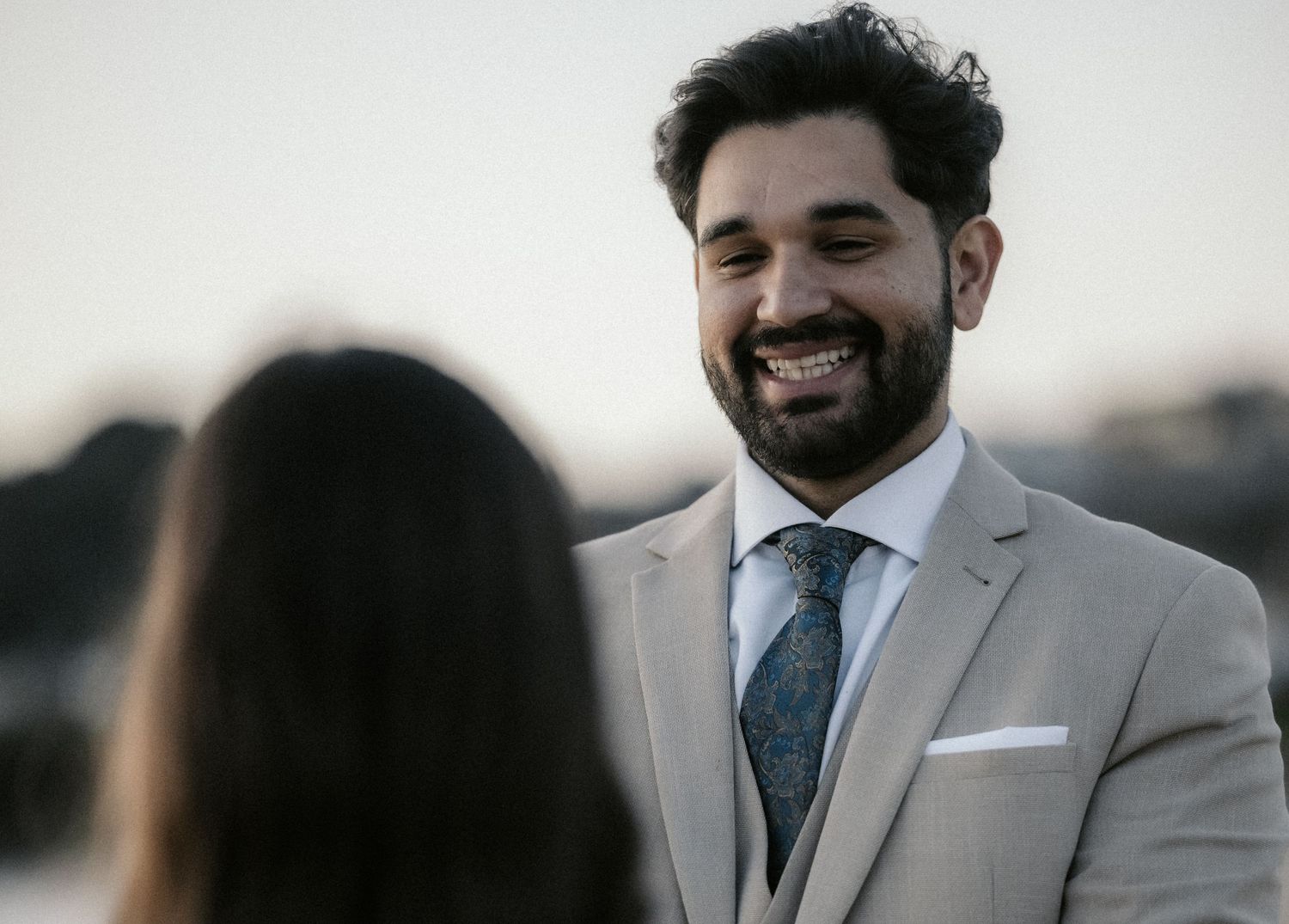 A collection of candid wedding portraits showing joyful expressions and embraces.