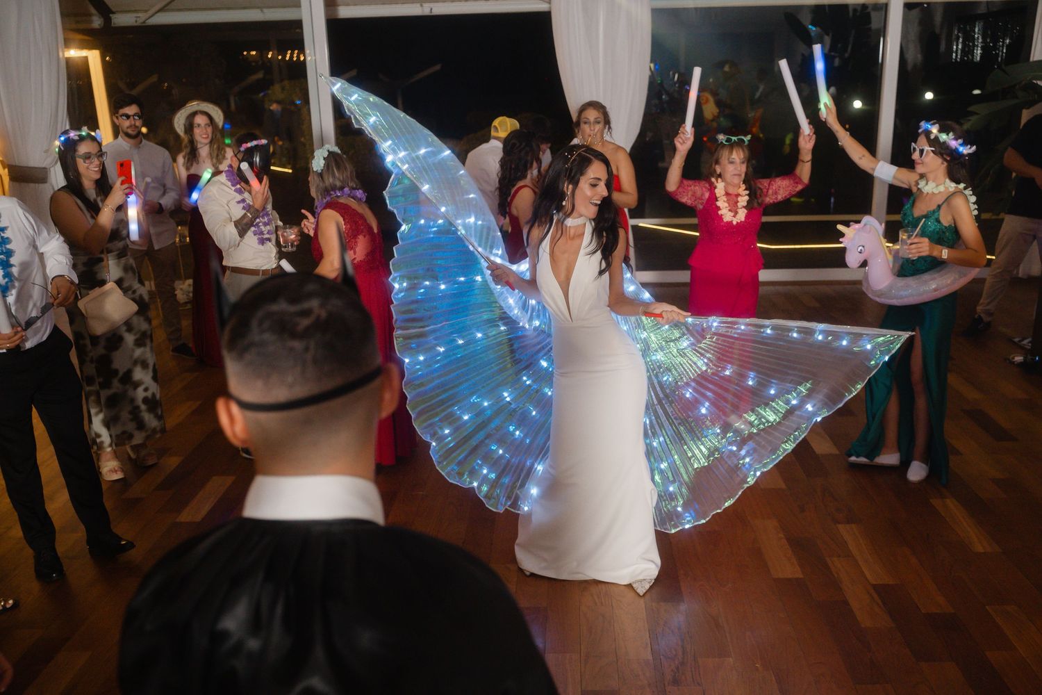 A dancer in an illuminated LED butterfly wing costume creates a magical moment on the dance floor.