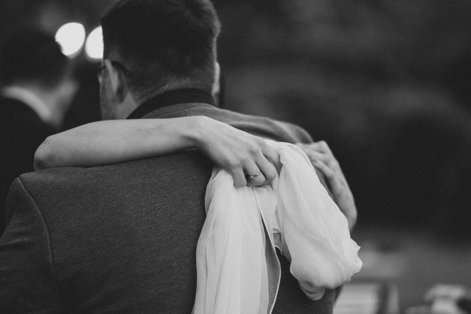 Black and white photo series showing intimate moments of a couple embracing and dancing together.