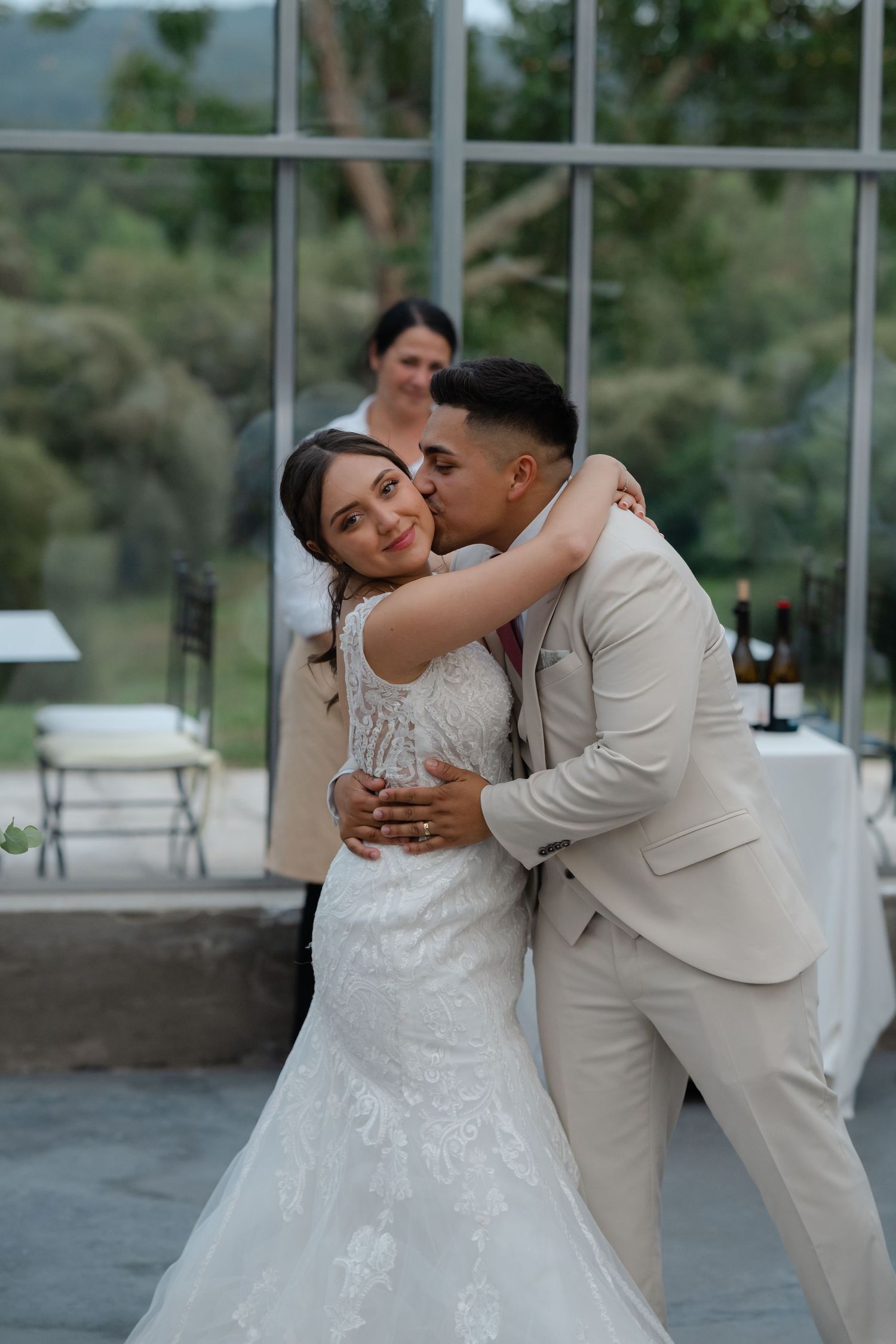 A romantic wedding photoshoot series showing tender moments between newlyweds in a light-filled venue.