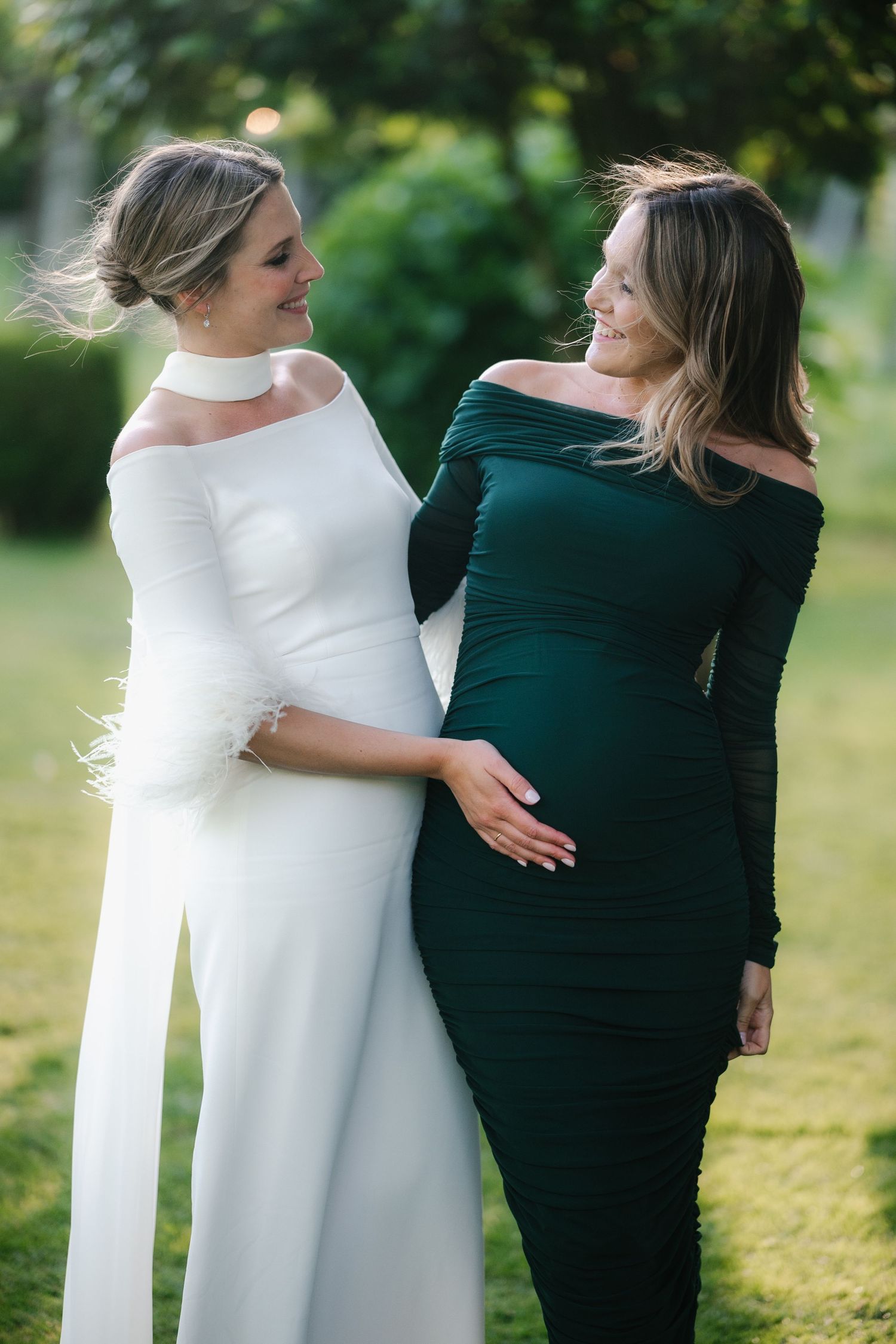 A sequence of candid moments showing two people in white and dark outfits embracing outdoors in a garden setting.