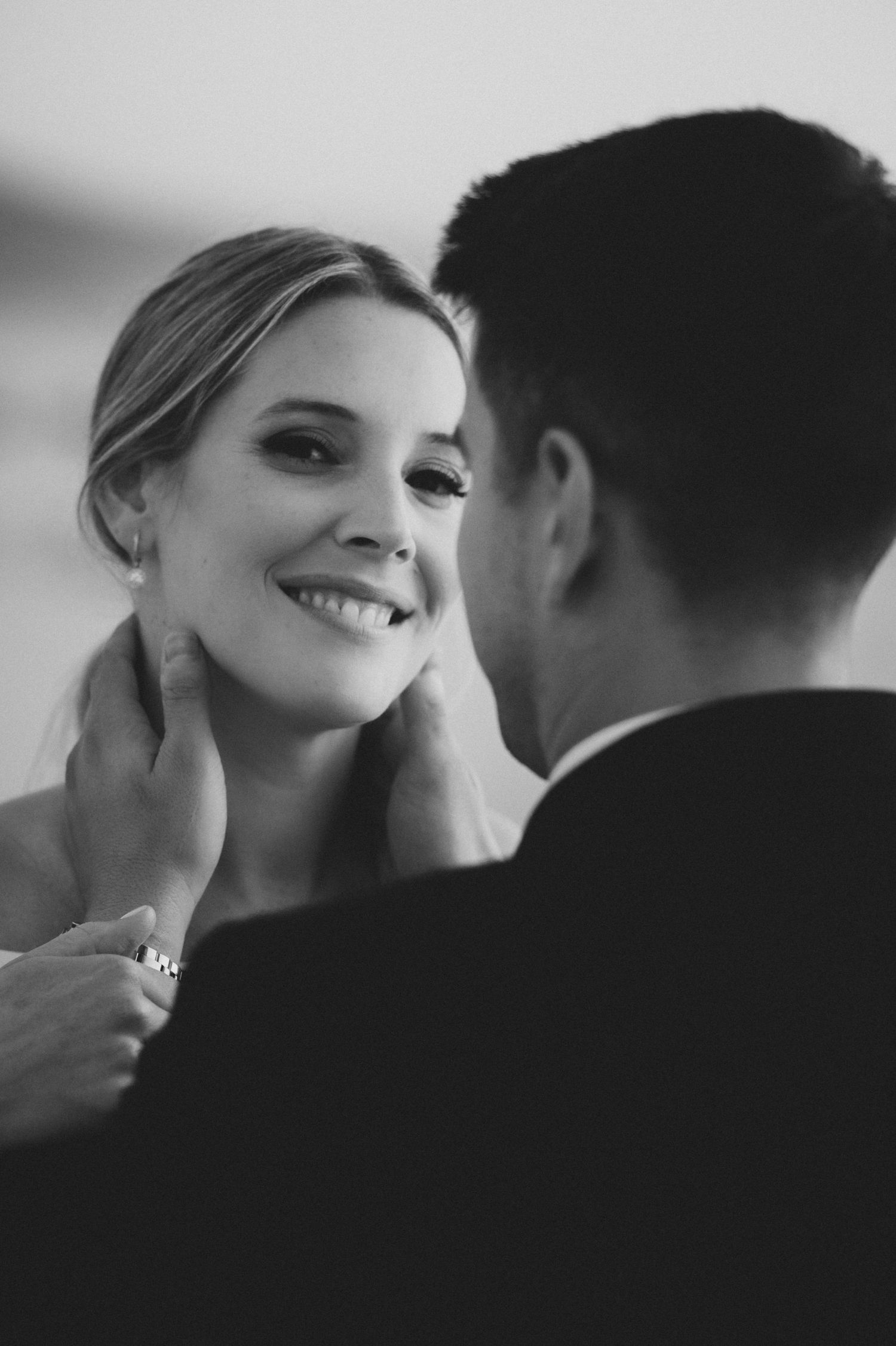 Intimate black and white close-up portrait of a couple sharing a romantic moment.