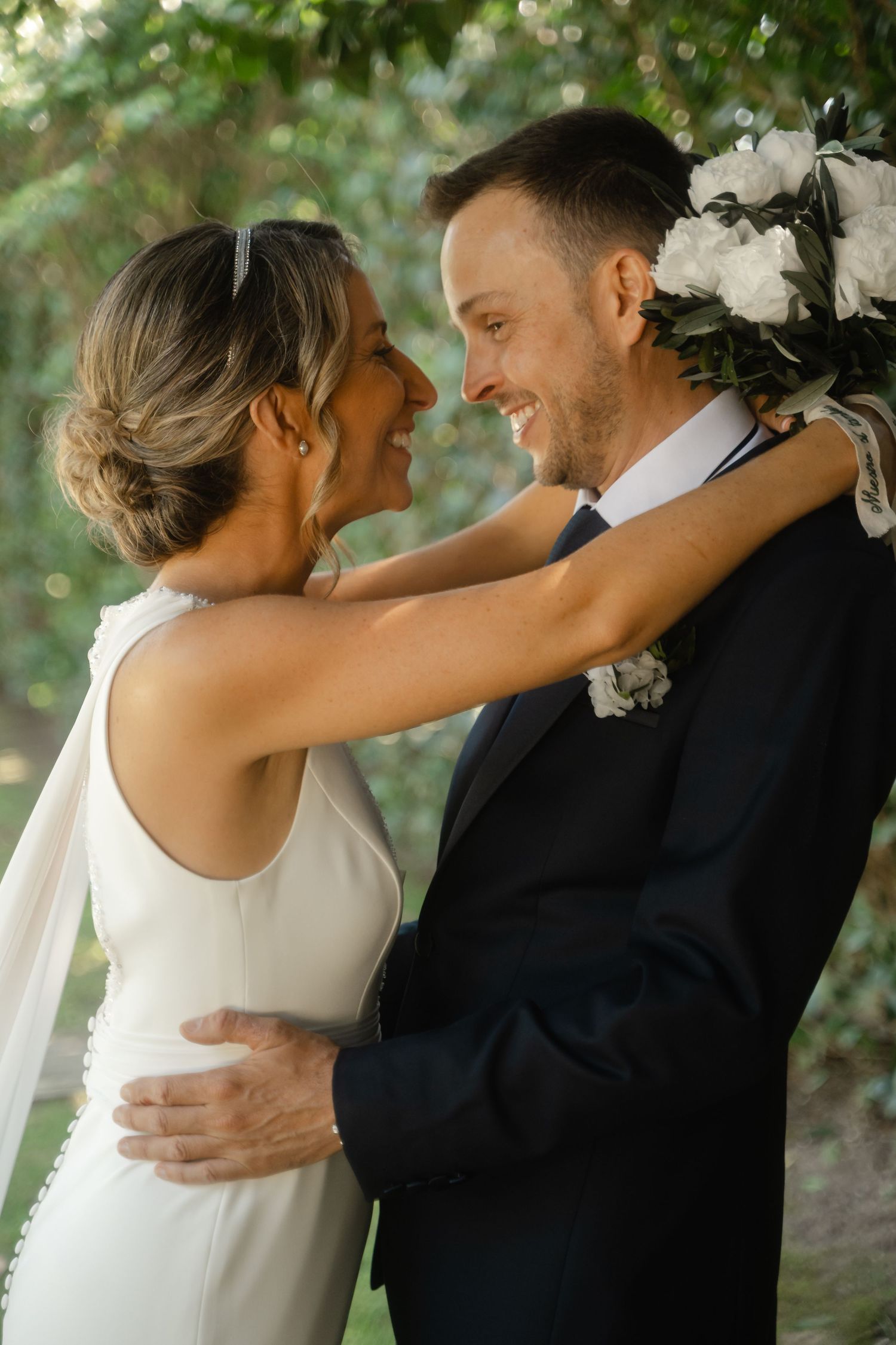 Tender wedding photography sequence showing romantic embraces outdoors with natural greenery in the background.
