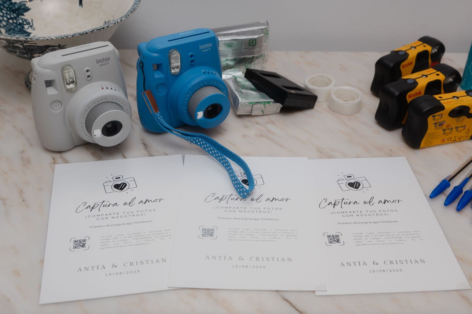 Several smart home security cameras and devices arranged on a white surface with installation paperwork and tools.