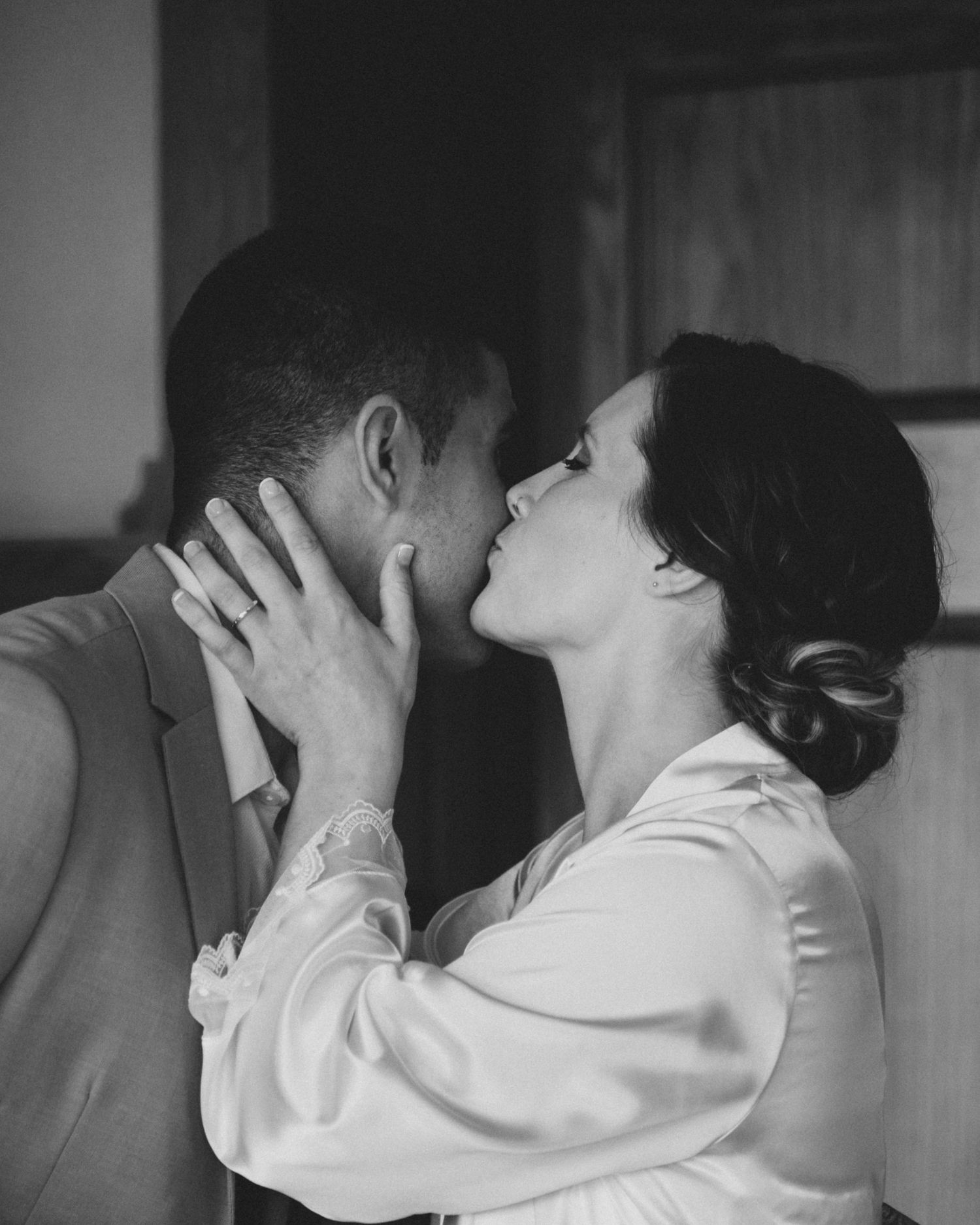 A black and white photo sequence showing a couple in an intimate embrace and kiss.