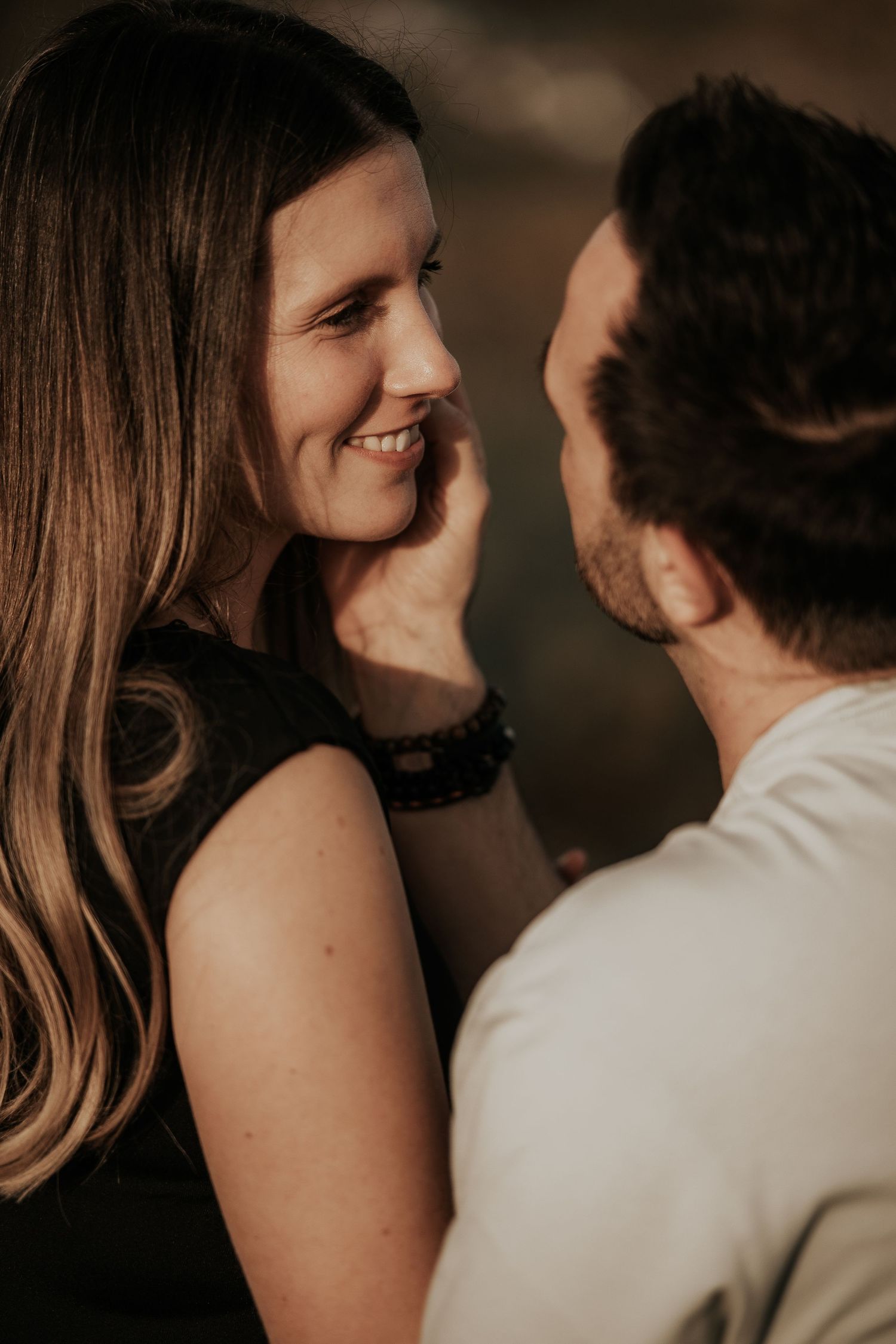 A romantic couple shares intimate close-up moments in a series of candid portrait shots.