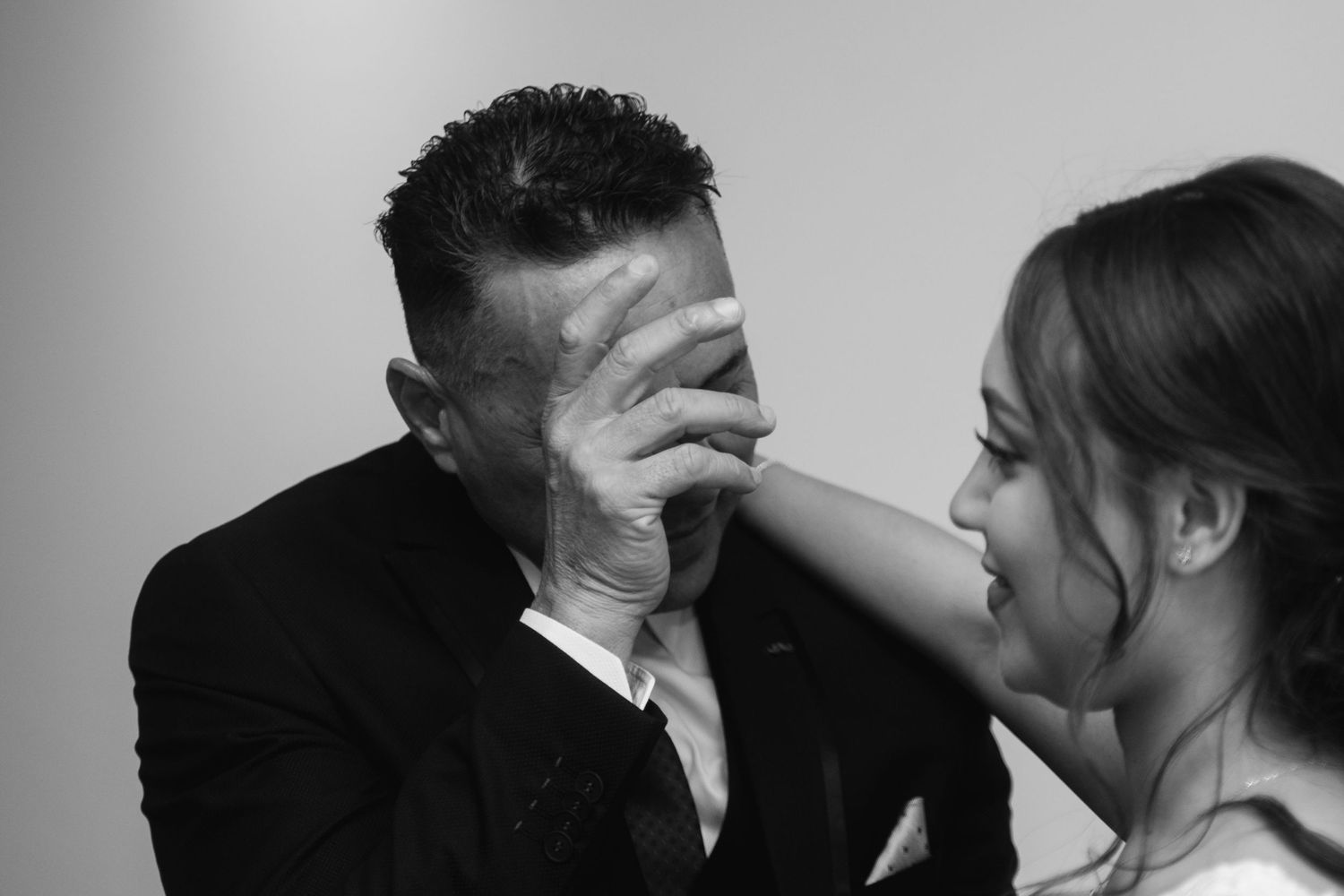 Romantic black and white photo series showing tender moments between a bride and groom.