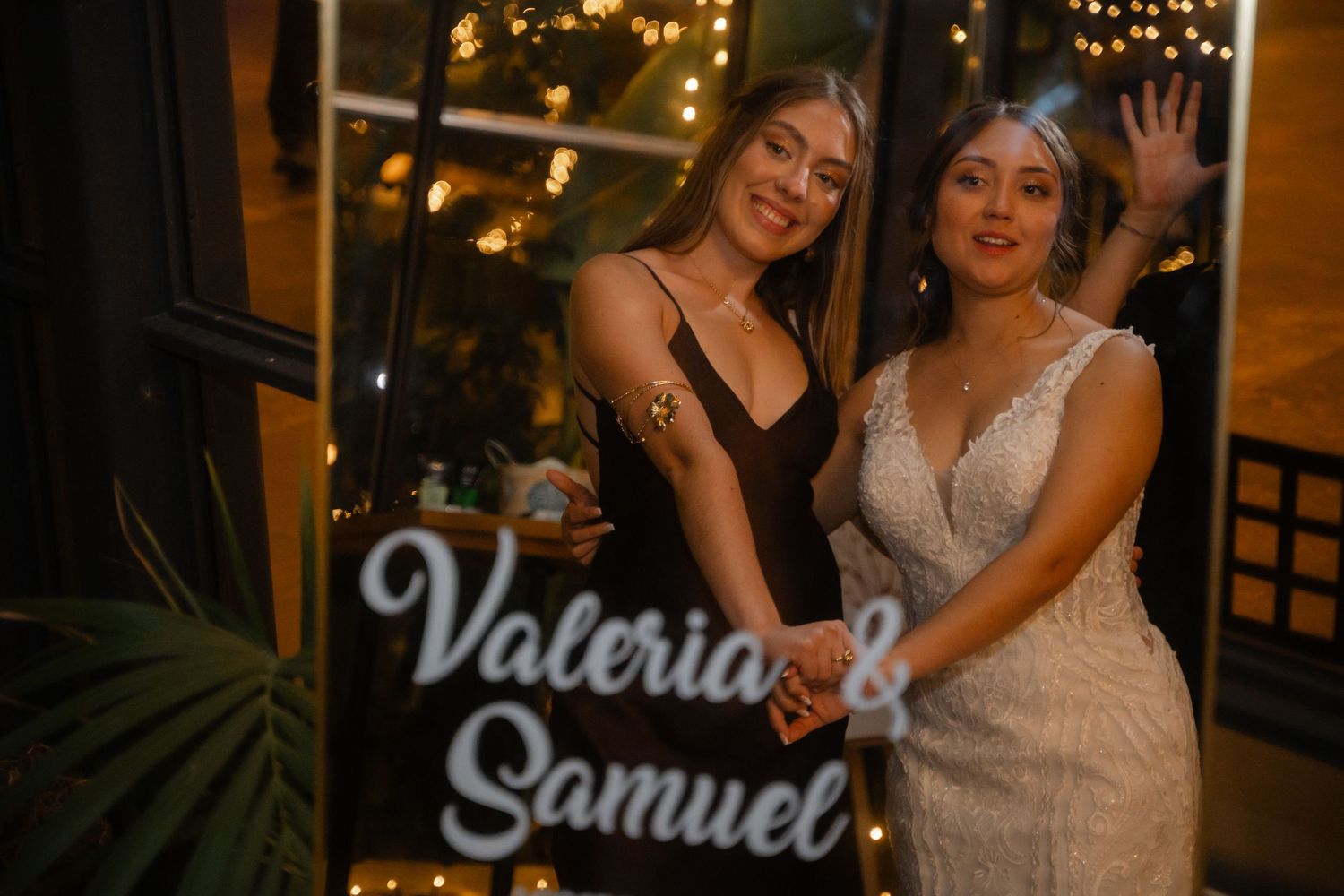 Celebration event with string lights and decorative signage in an intimate indoor venue.