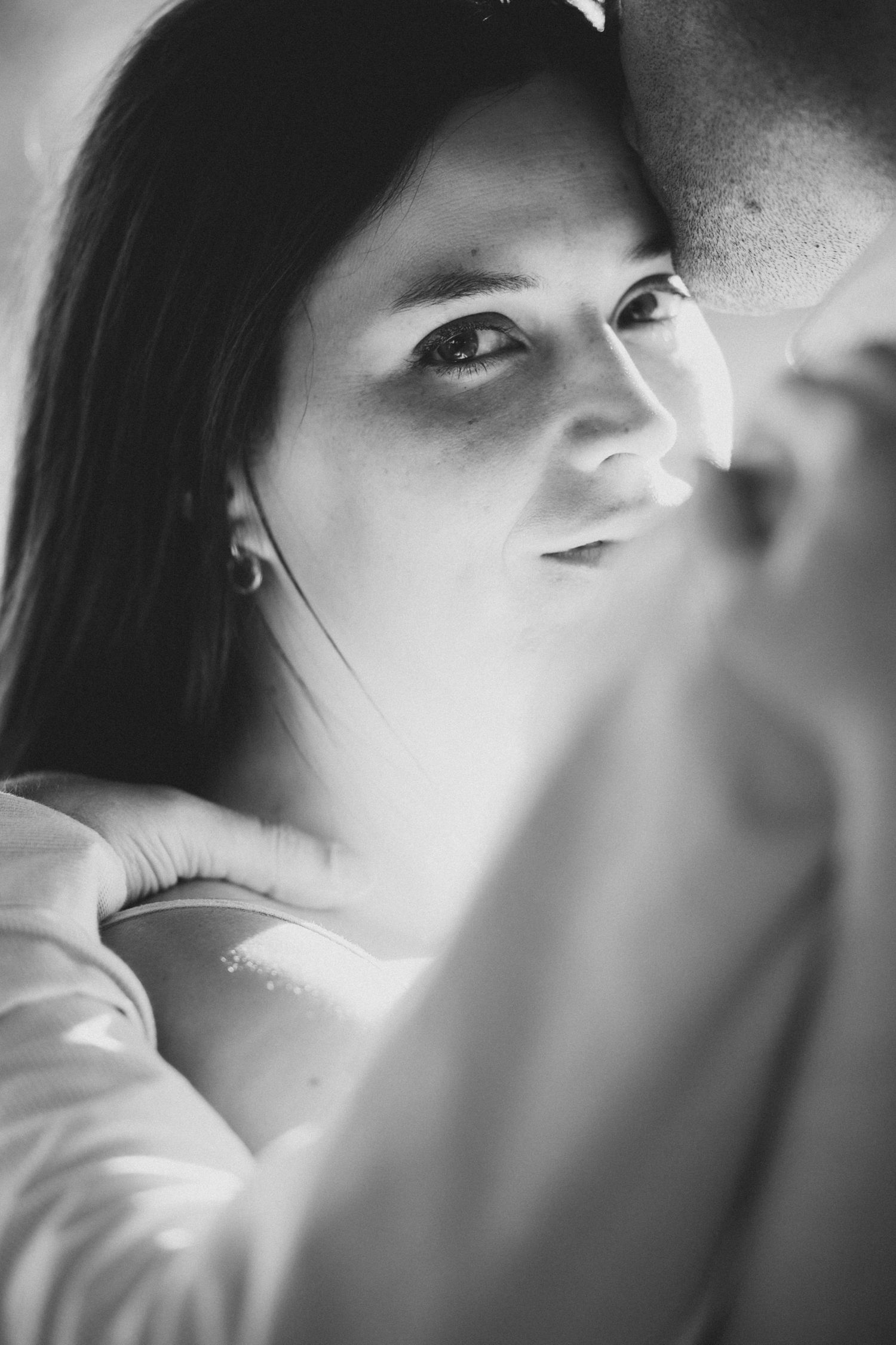 Intimate black and white close-up portrait series showing soft expressions and gentle lighting.