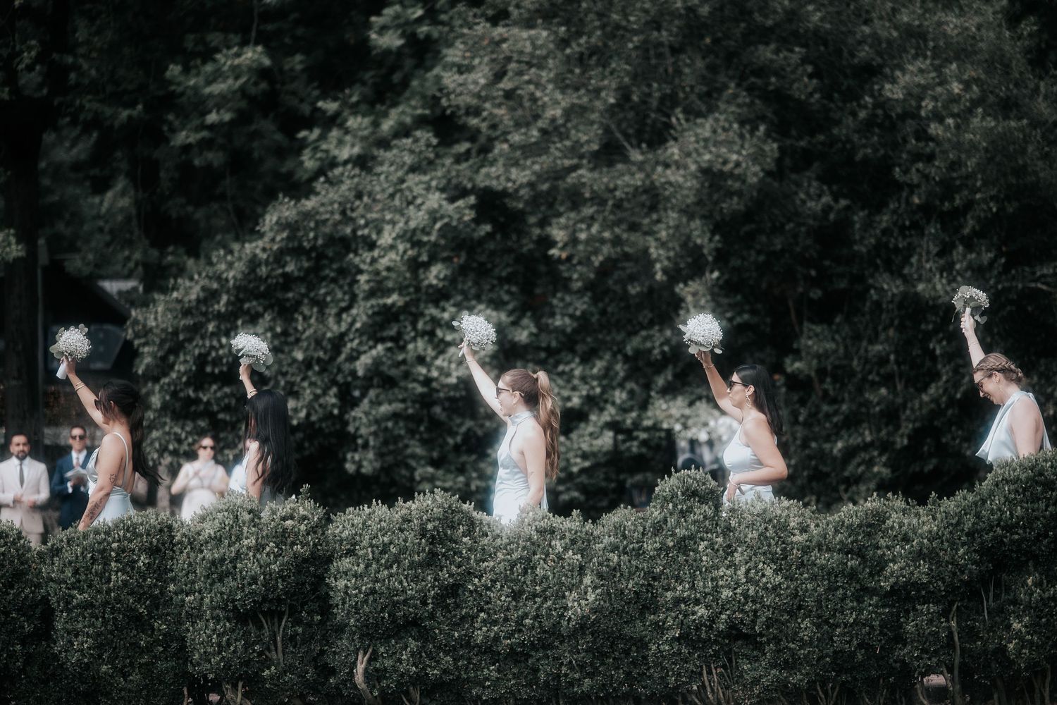 A sequence of wedding photos showing people celebrating and dancing outdoors in a garden setting.