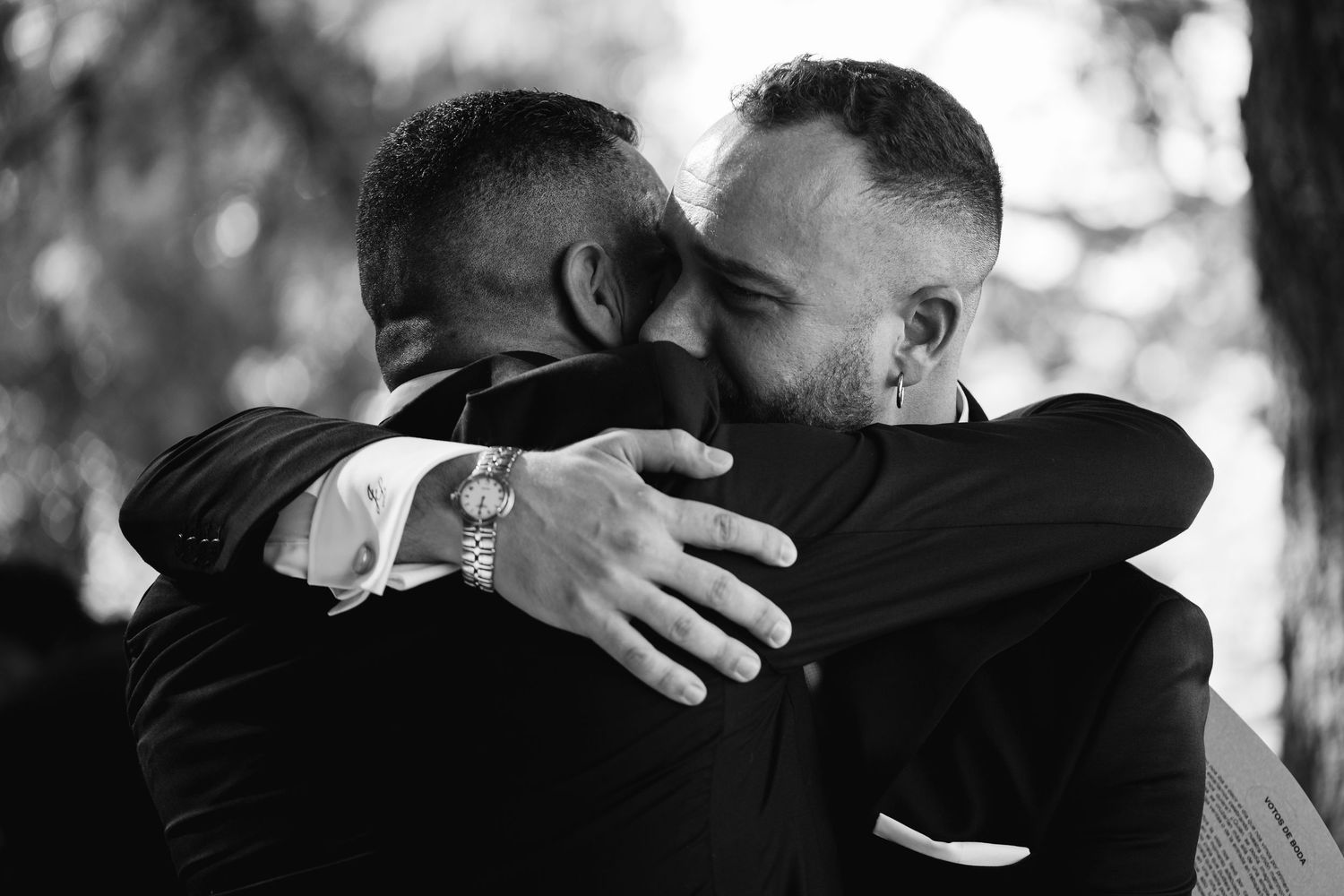 A series of black and white photos showing emotional embraces between people in a candid documentary style.