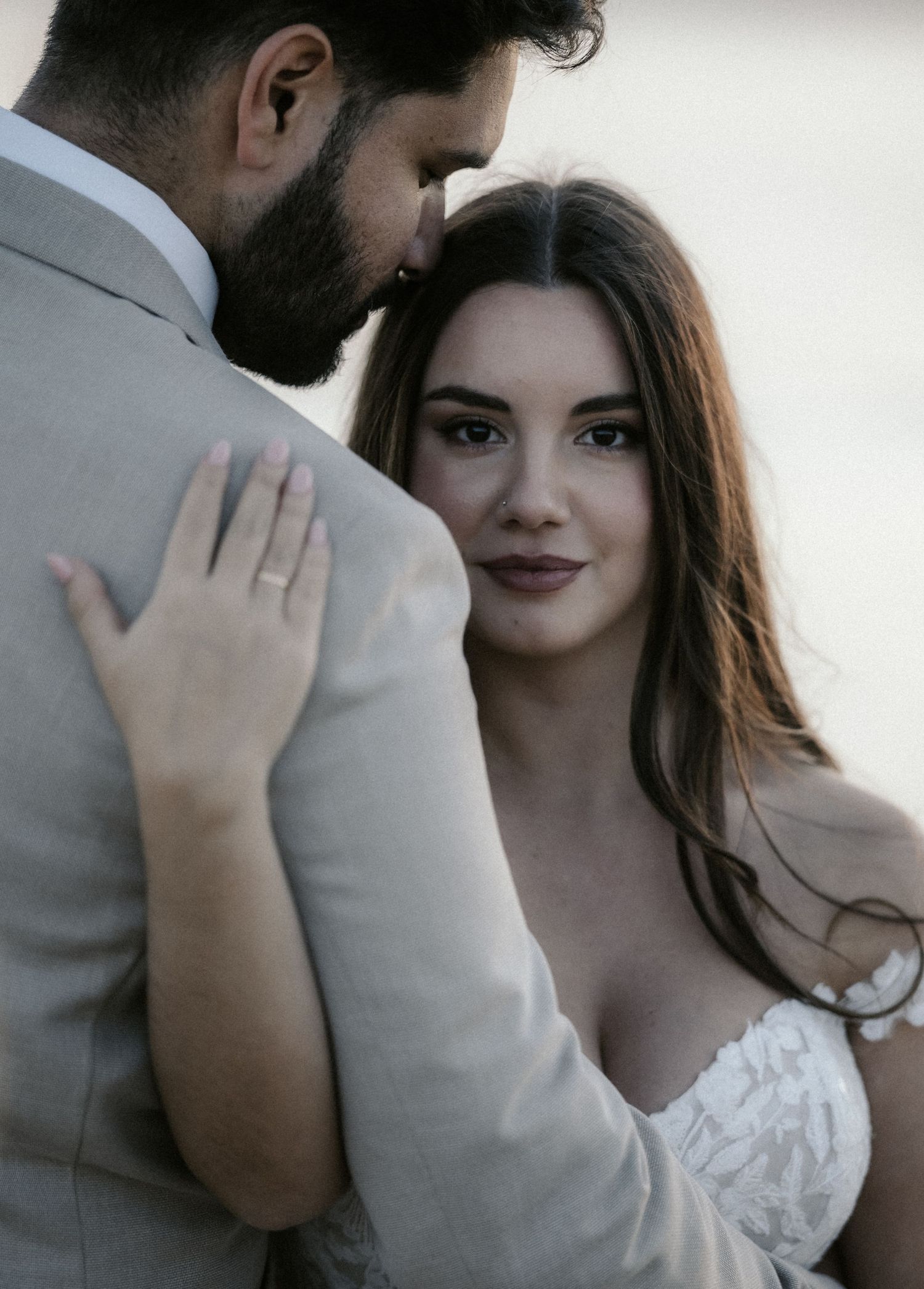 A romantic wedding photoshoot sequence showing tender moments between a couple in formal attire.