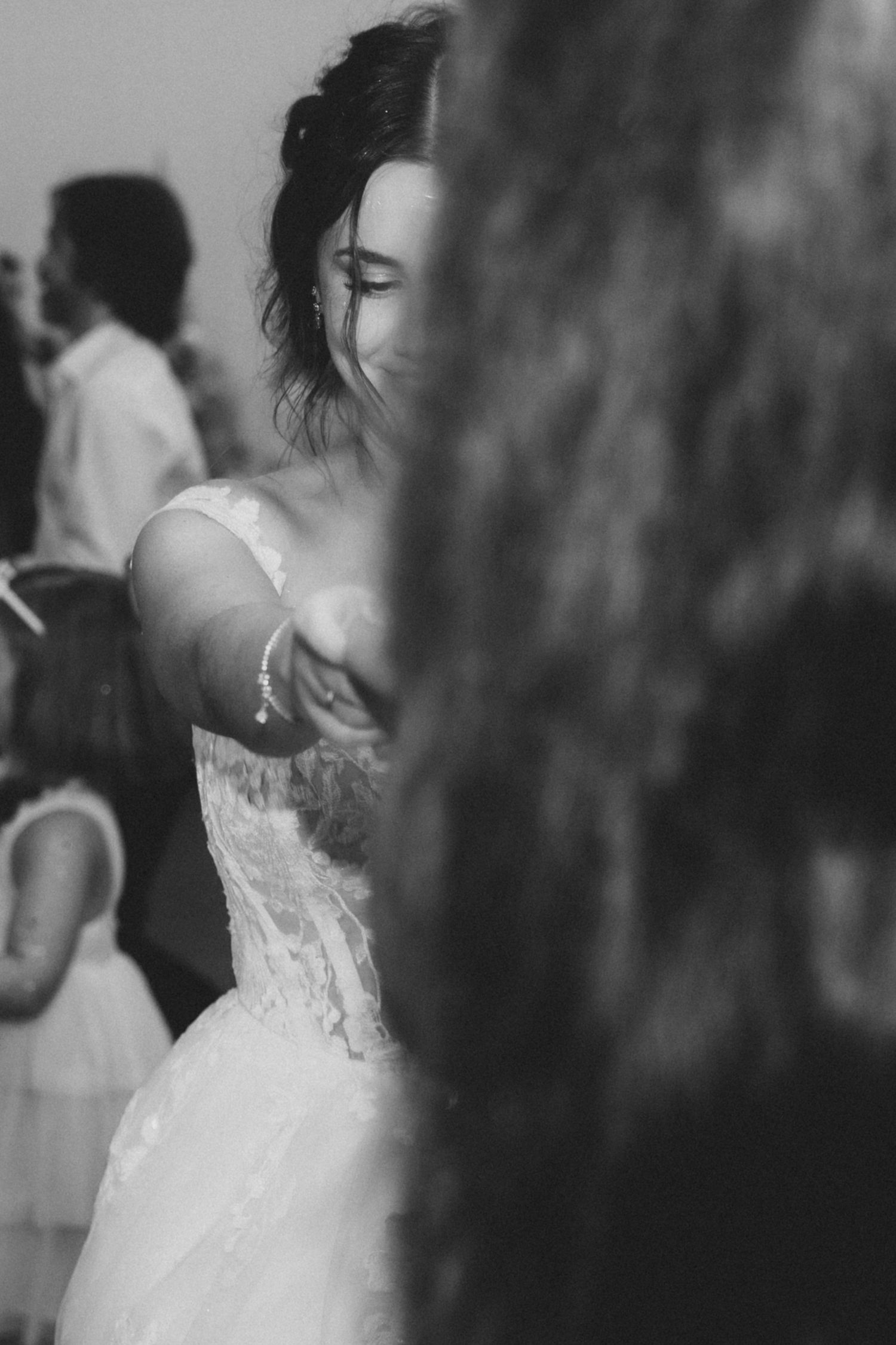 A romantic black and white capture of a couple's intimate dance moment at their wedding.
