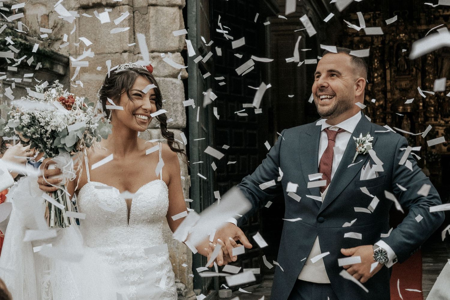 Joyful wedding celebration with confetti flying through the air as newlyweds share happy moments.