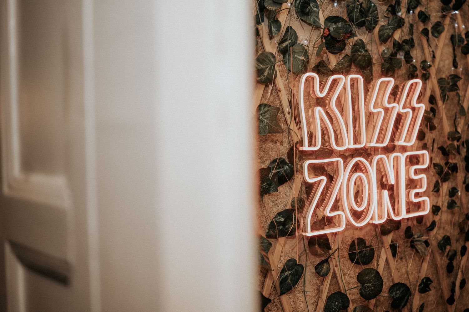 A collection of vintage-style neon signs mounted on a wall with glowing text and decorative elements.