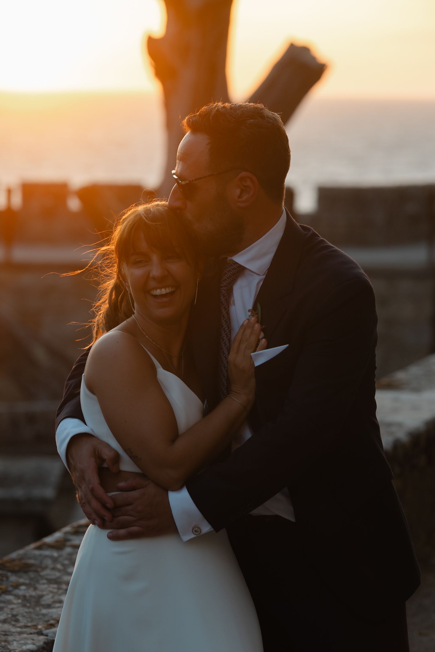 Intimate sunset wedding portraits with golden light and warm tones.