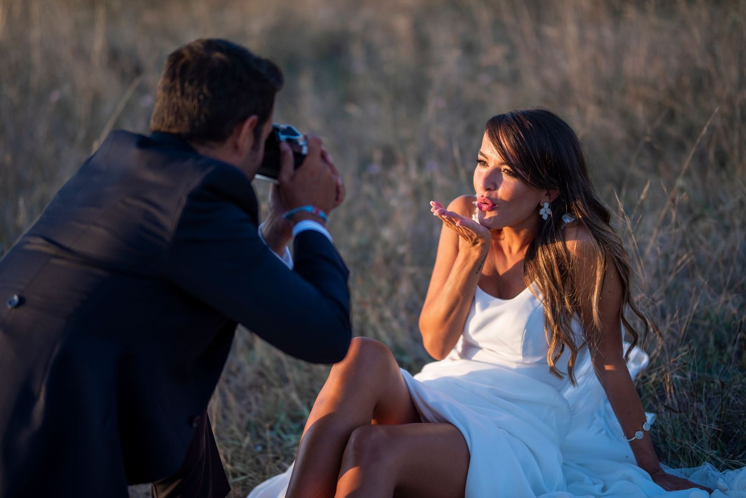 Couple shares intimate moment during sunset golden hour photography session.