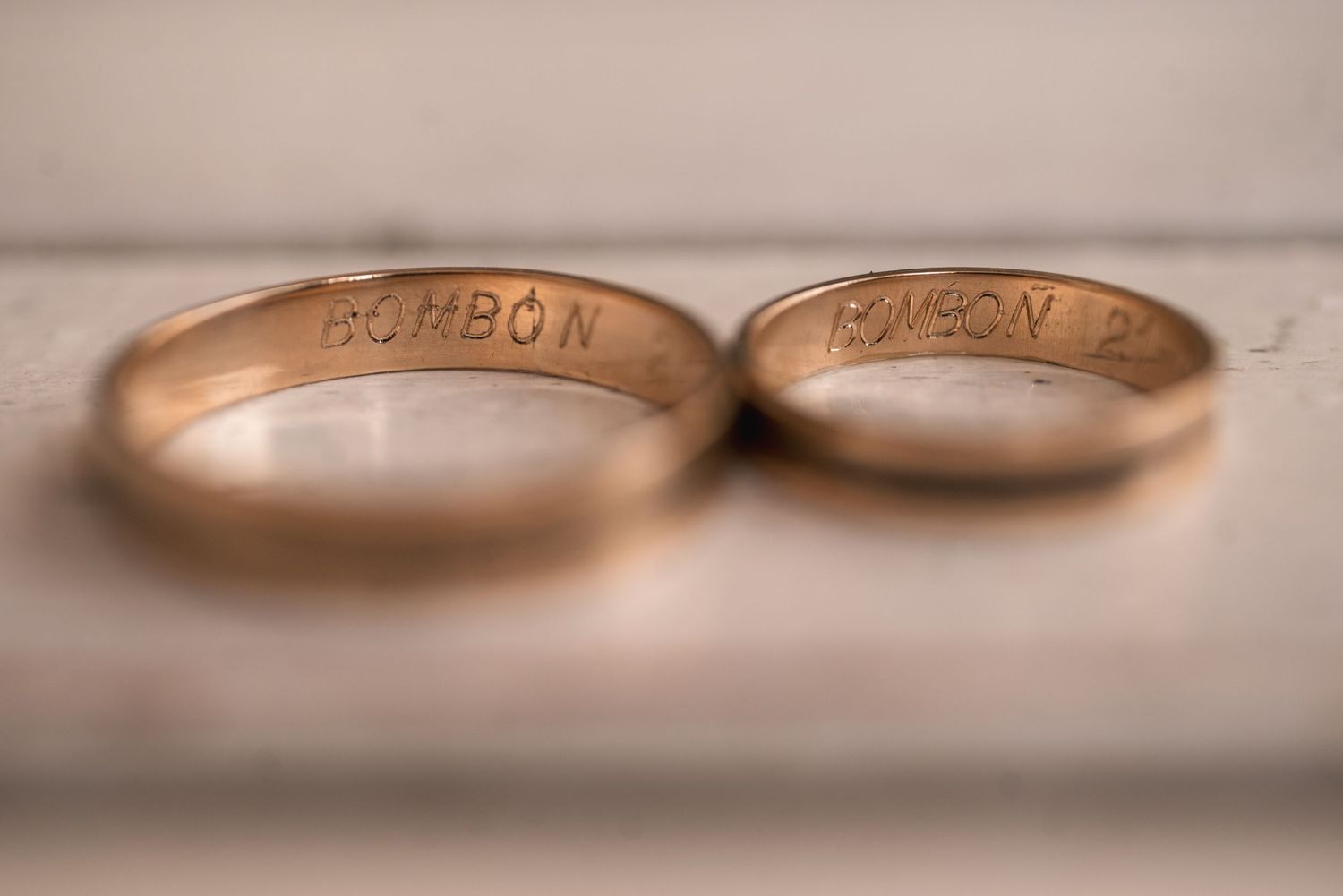 Close-up macro photos of rose gold wedding rings with engraved text showing different angles and details.