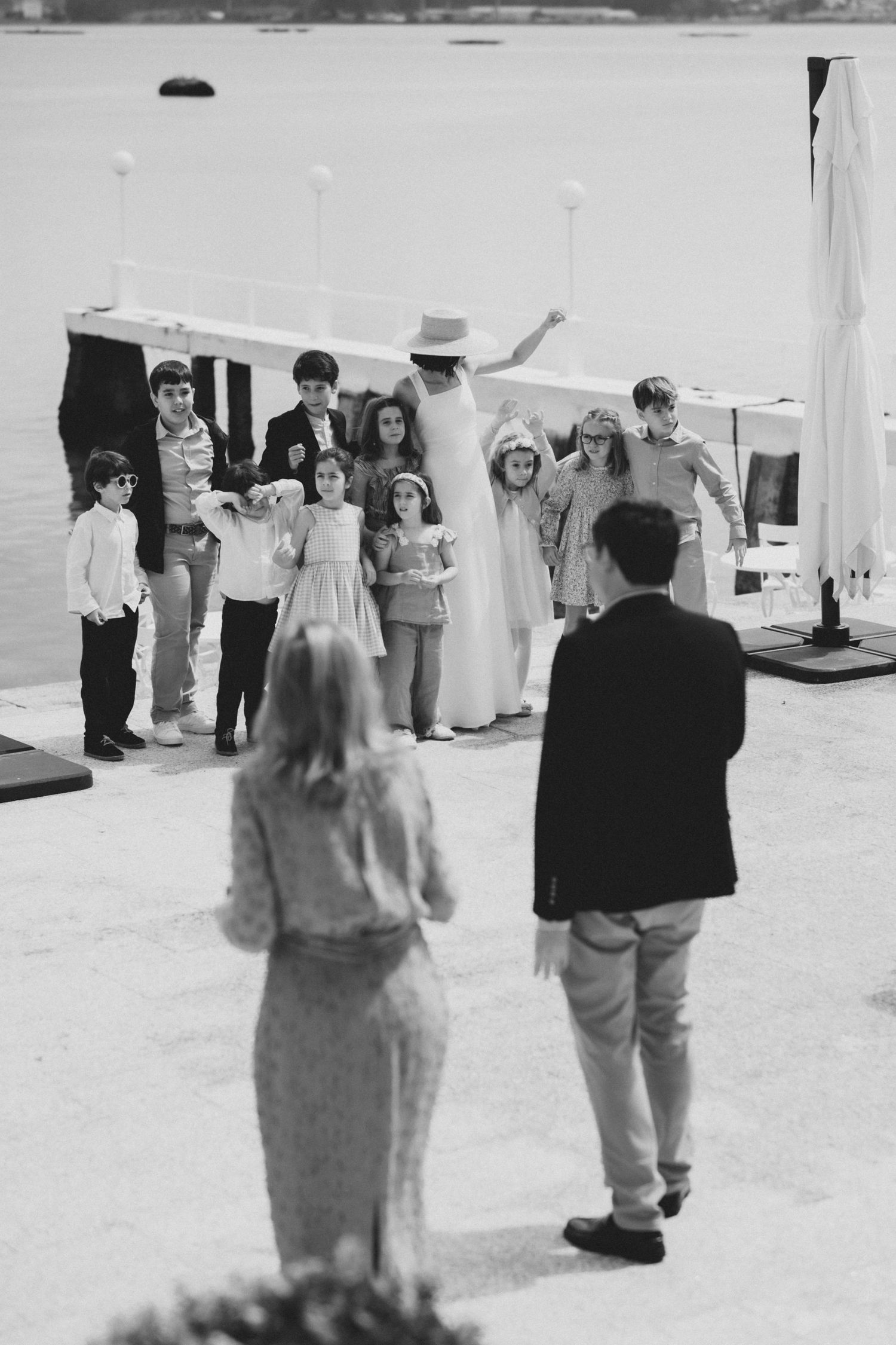 Vintage black and white photograph showing people dancing in formal attire at what appears to be a social gathering.