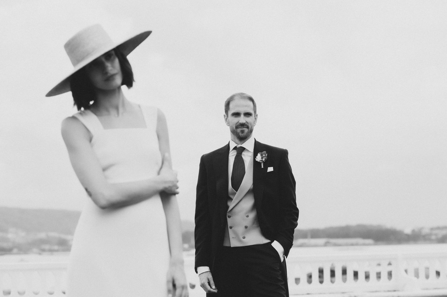 Black and white wedding portraits showing a couple walking together outdoors.