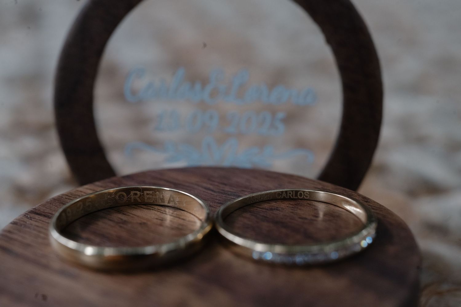 Close-up view of a rustic wedding ring on a textured stone surface with blurred background.