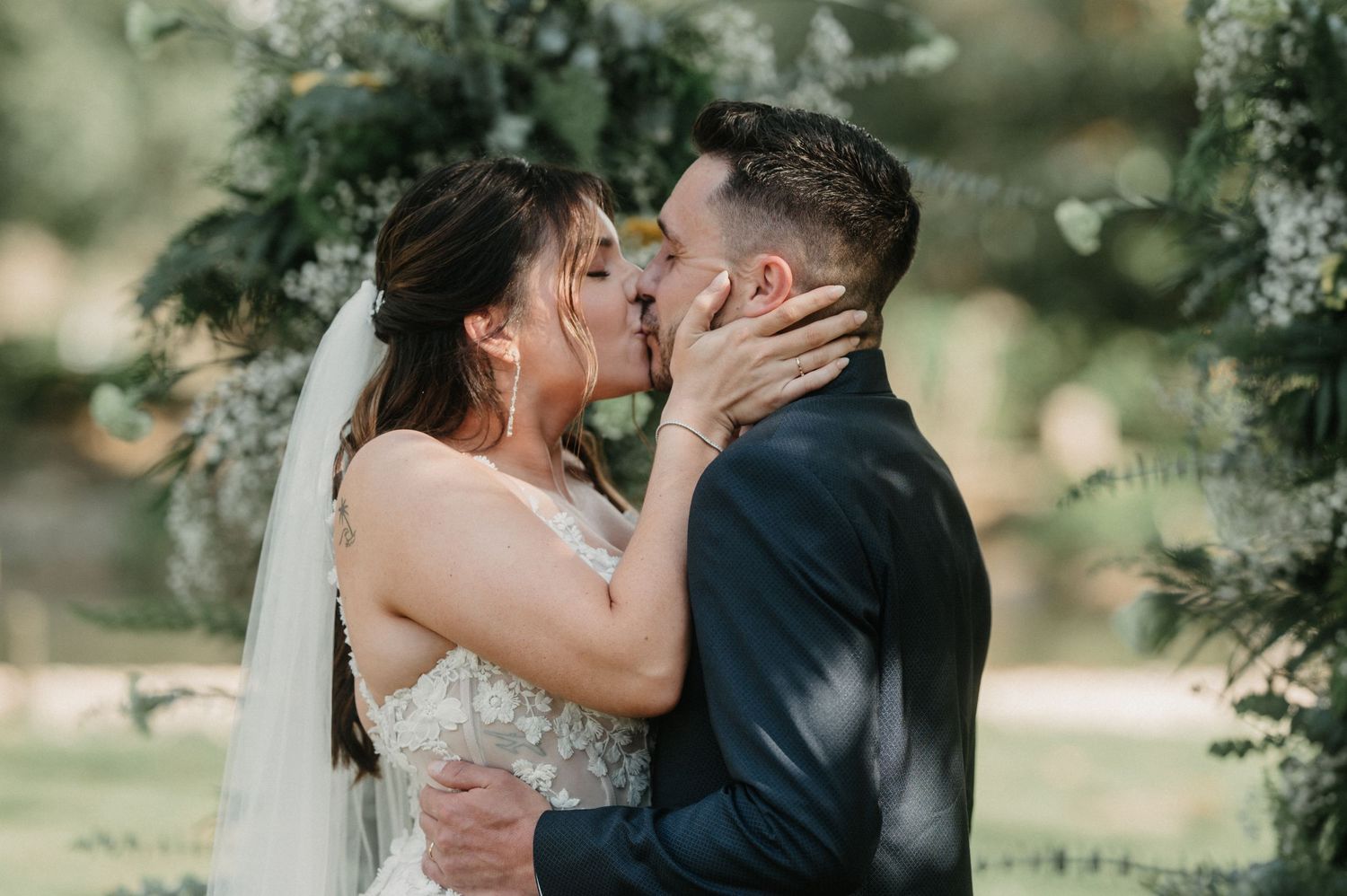 Romantic moment captured during an outdoor wedding ceremony.