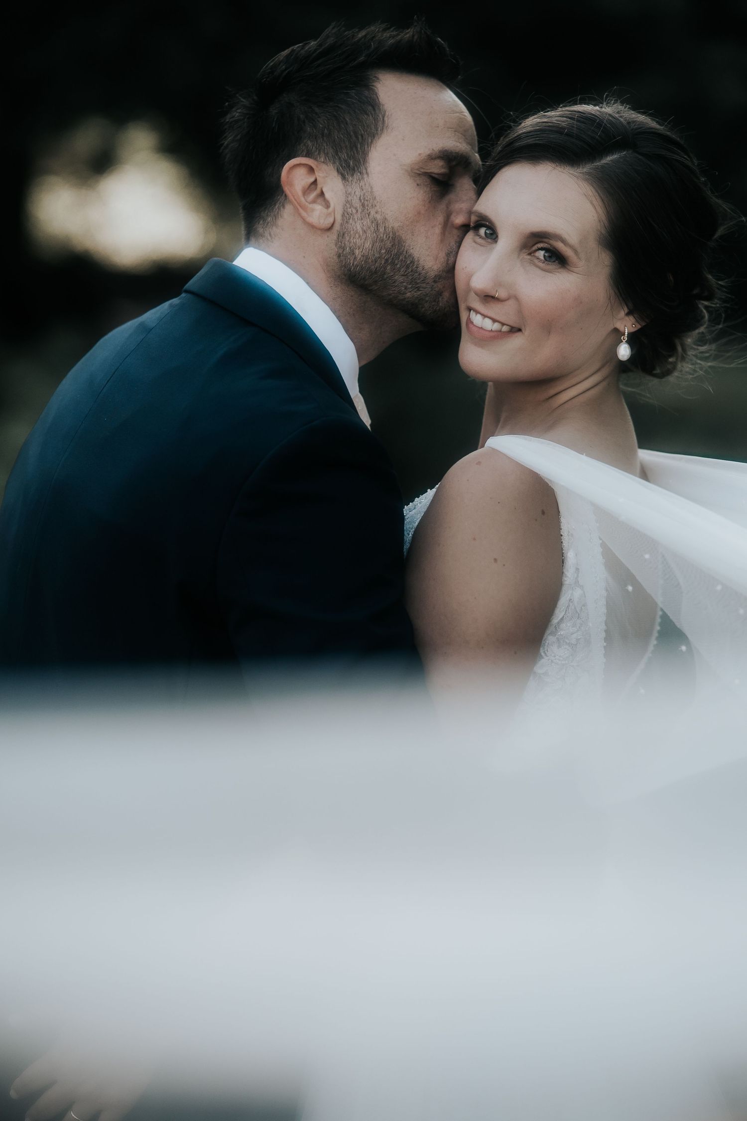 Romantic black and white wedding portrait sequence with bride's veil flowing in the breeze.