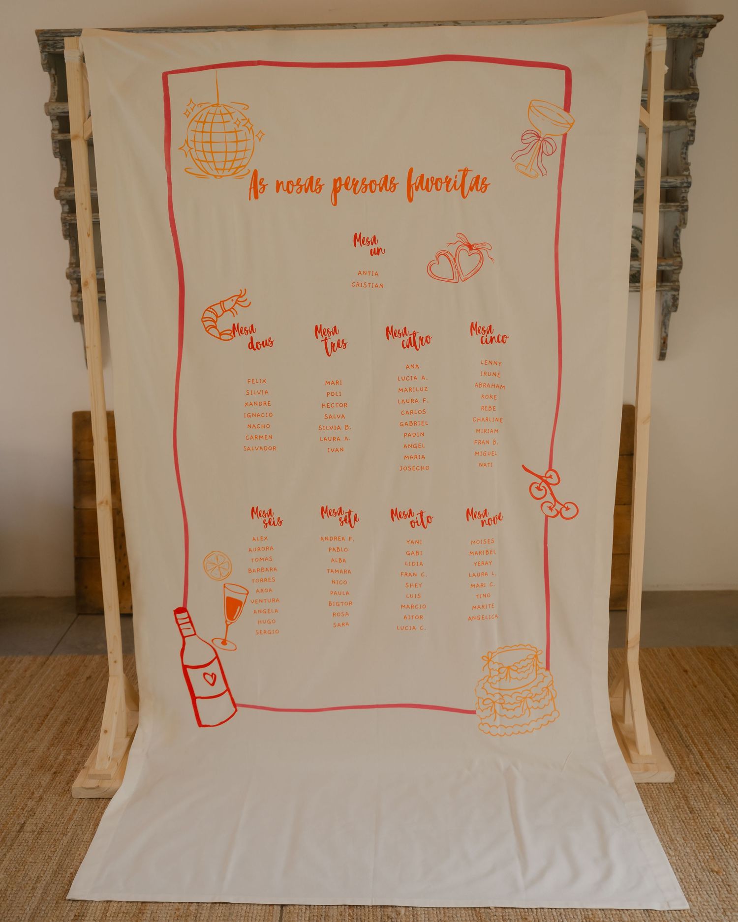 A series of white fabric panels with red hand-drawn seating chart designs displayed against a light background.