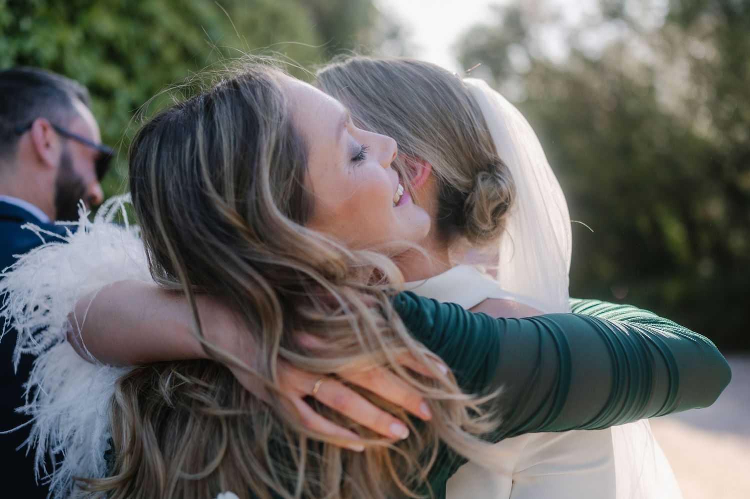 A romantic outdoor wedding moment captured in a garden setting with natural sunlight filtering through.