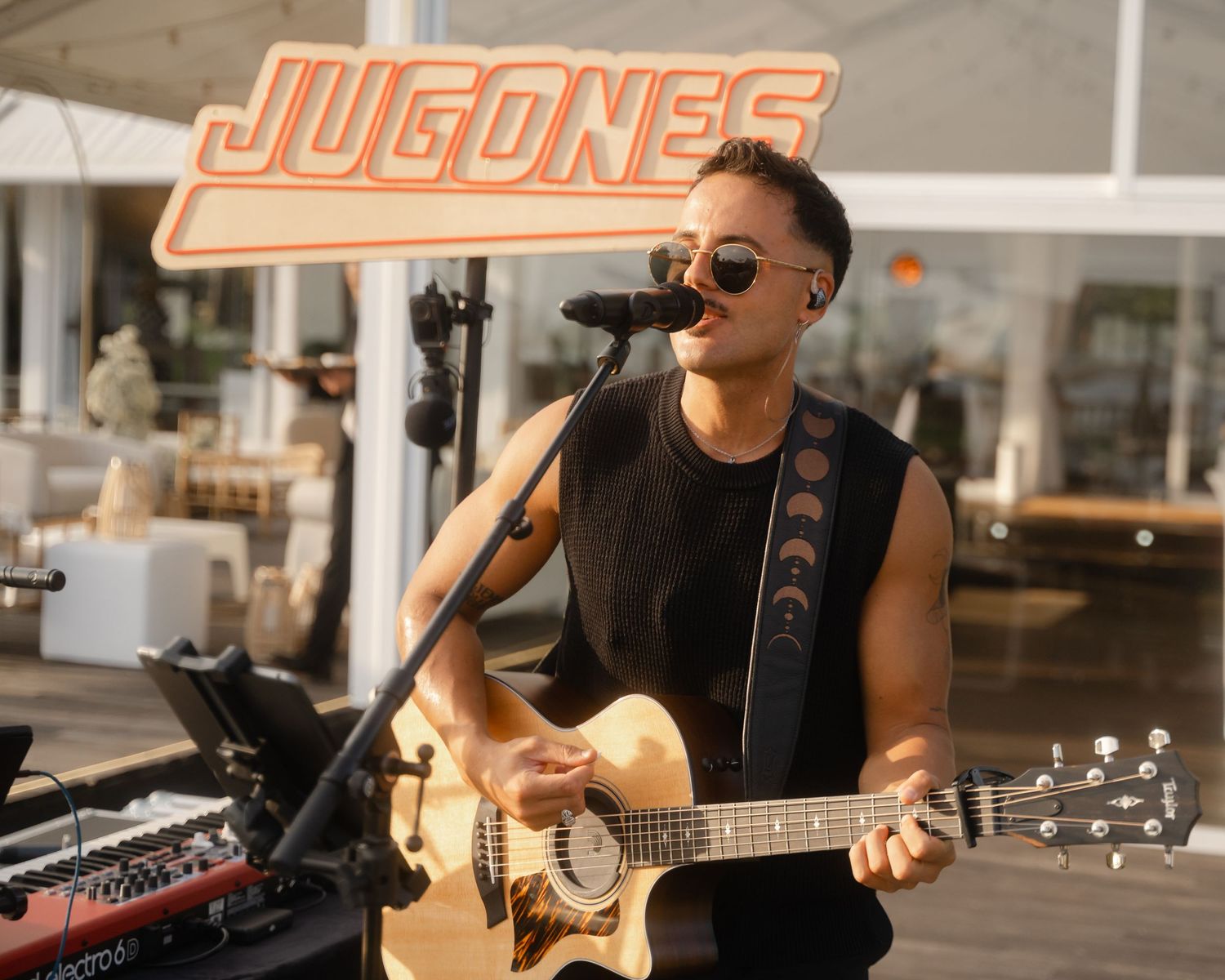 Live band performs on stage with guitars and musical equipment.