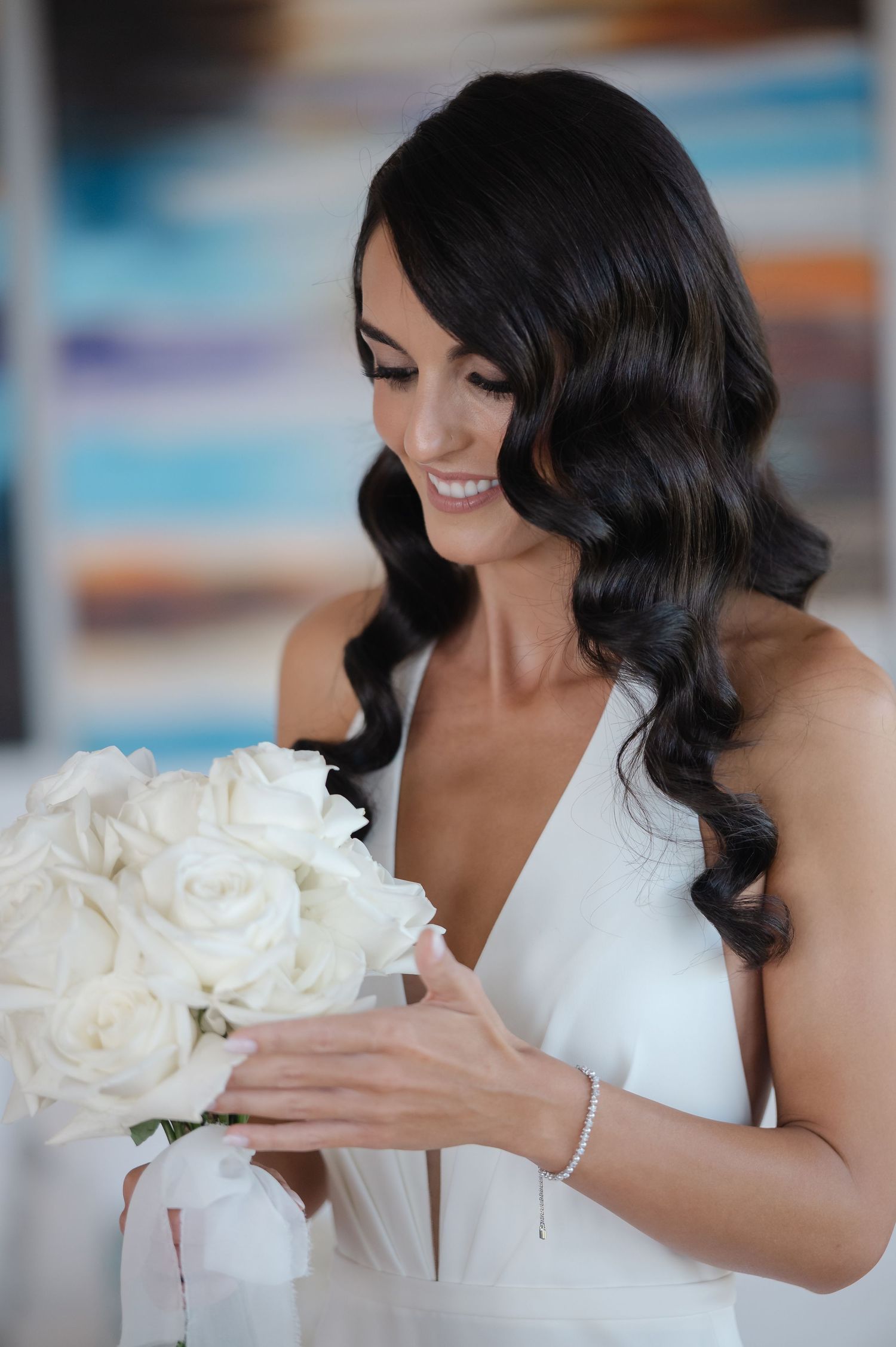 A bride in a white dress holds a luxurious bouquet of white peonies while posing in a romantic sequence of photos.