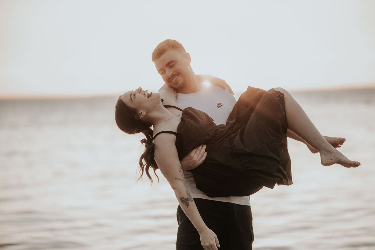 Couple dancing together against bright white studio backdrop.