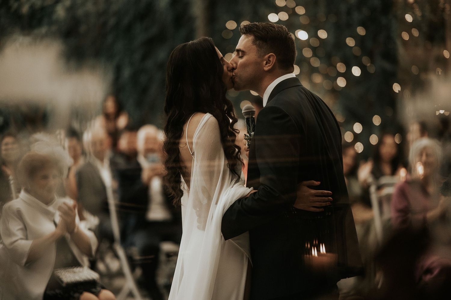Wedding reception scene with string lights creating romantic ambiance.