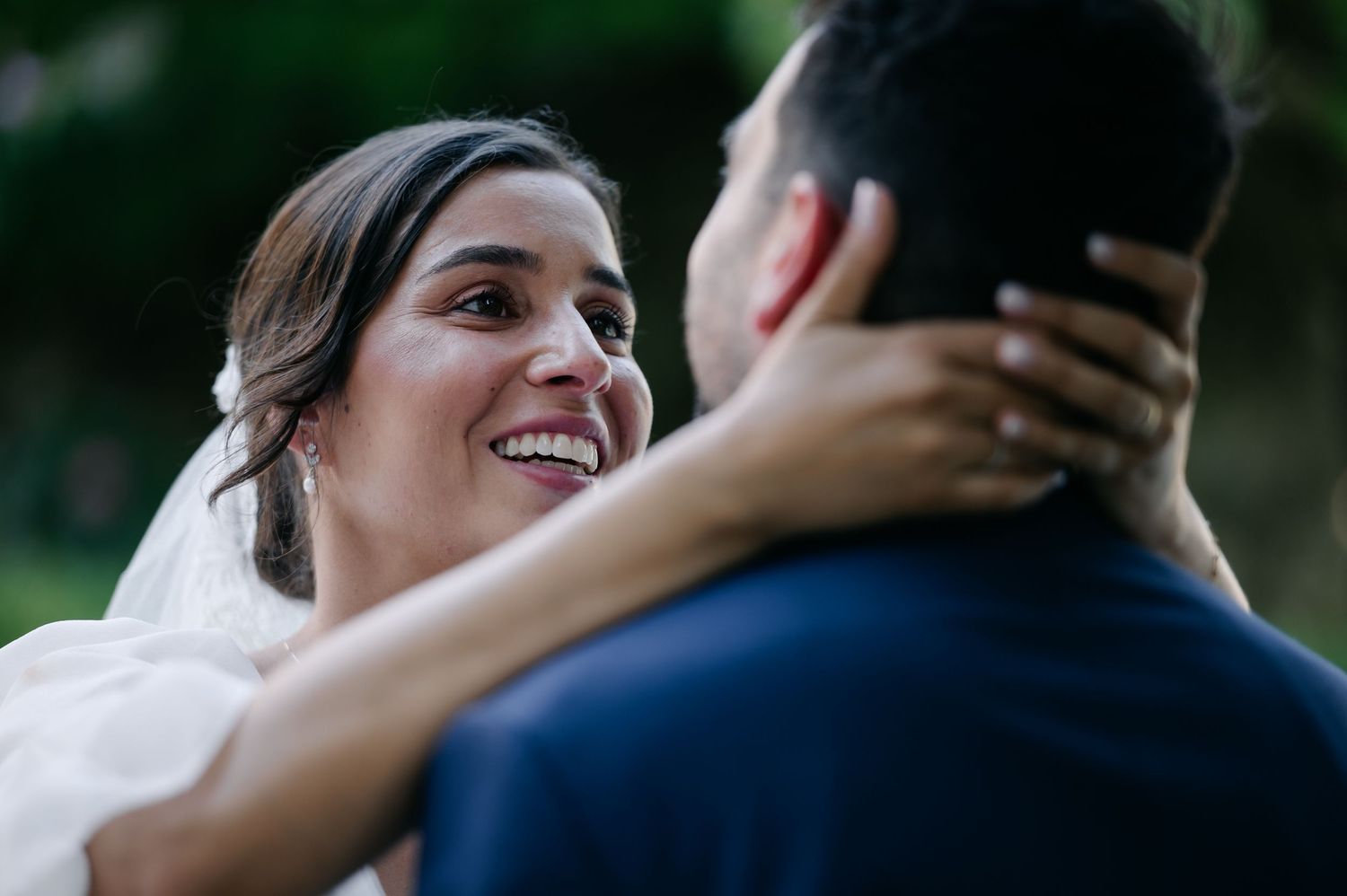 A series of candid wedding photos showing joyful embraces and tender moments between a couple during their celebration.