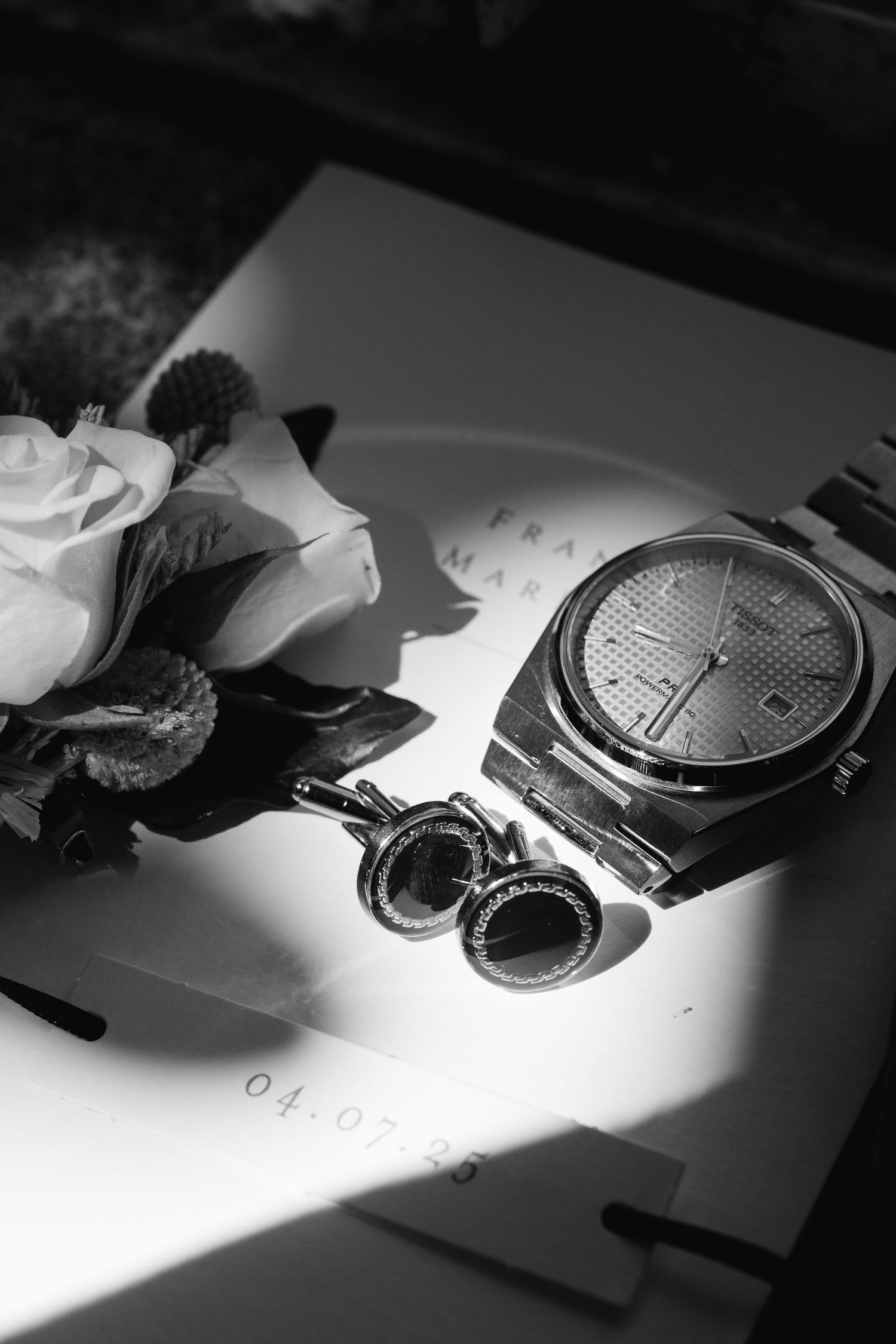 Black and white photo series showing a pocket watch being disassembled on a white surface in dramatic lighting.
