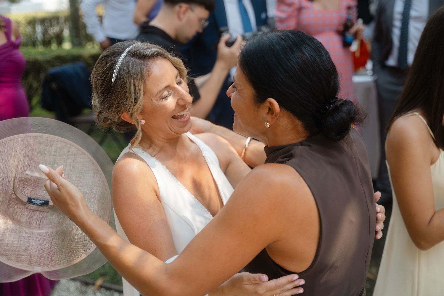 A series of candid moments showing wedding guests dancing and embracing at an outdoor celebration.